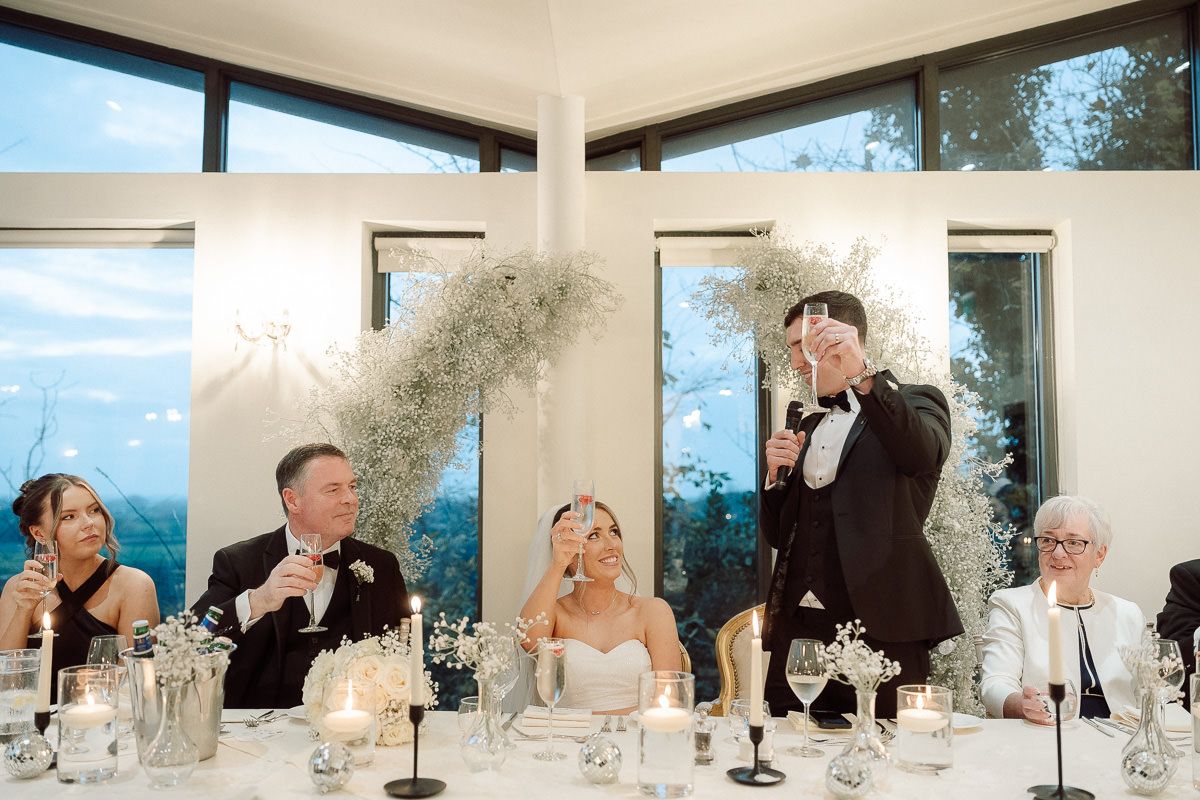 A series of candid wedding reception photos showing guests and wedding party enjoying speeches and toasts at tables.