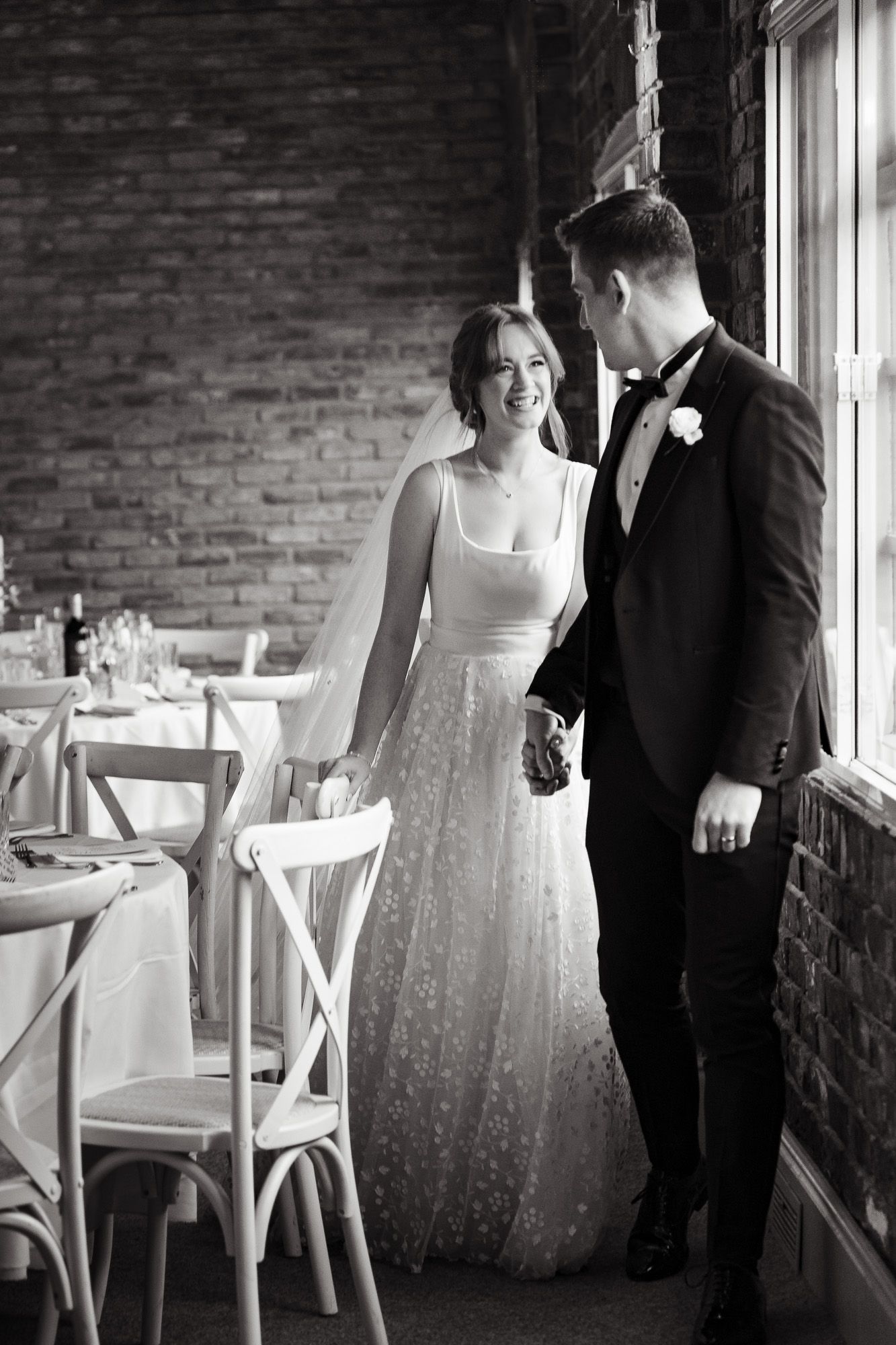 A black and white wedding sequence shows intimate moments between a couple in a rustic brick-walled reception venue.
