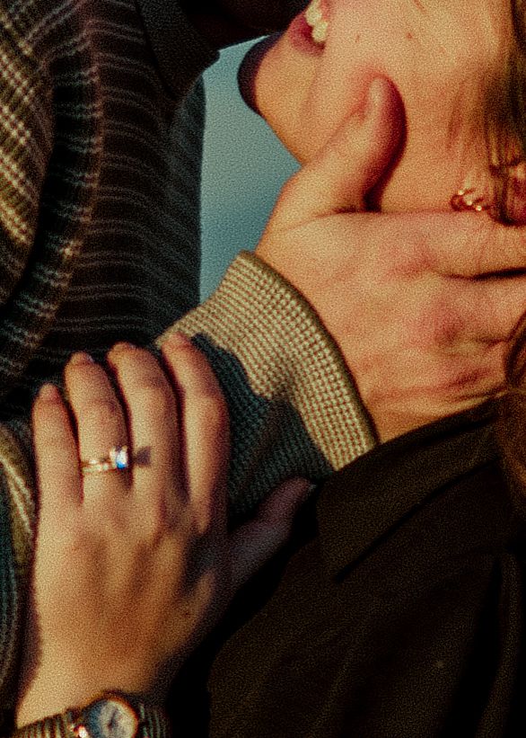 A close-up of a couple embracing, featuring an engagement ring and gold watch. Oklahoma City couple photoshoot.