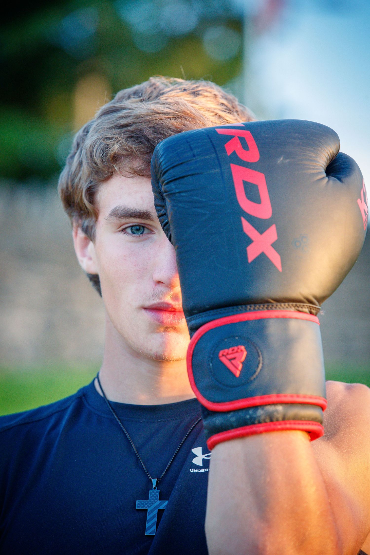 Boxer posing with a glove during an athletic portrait session