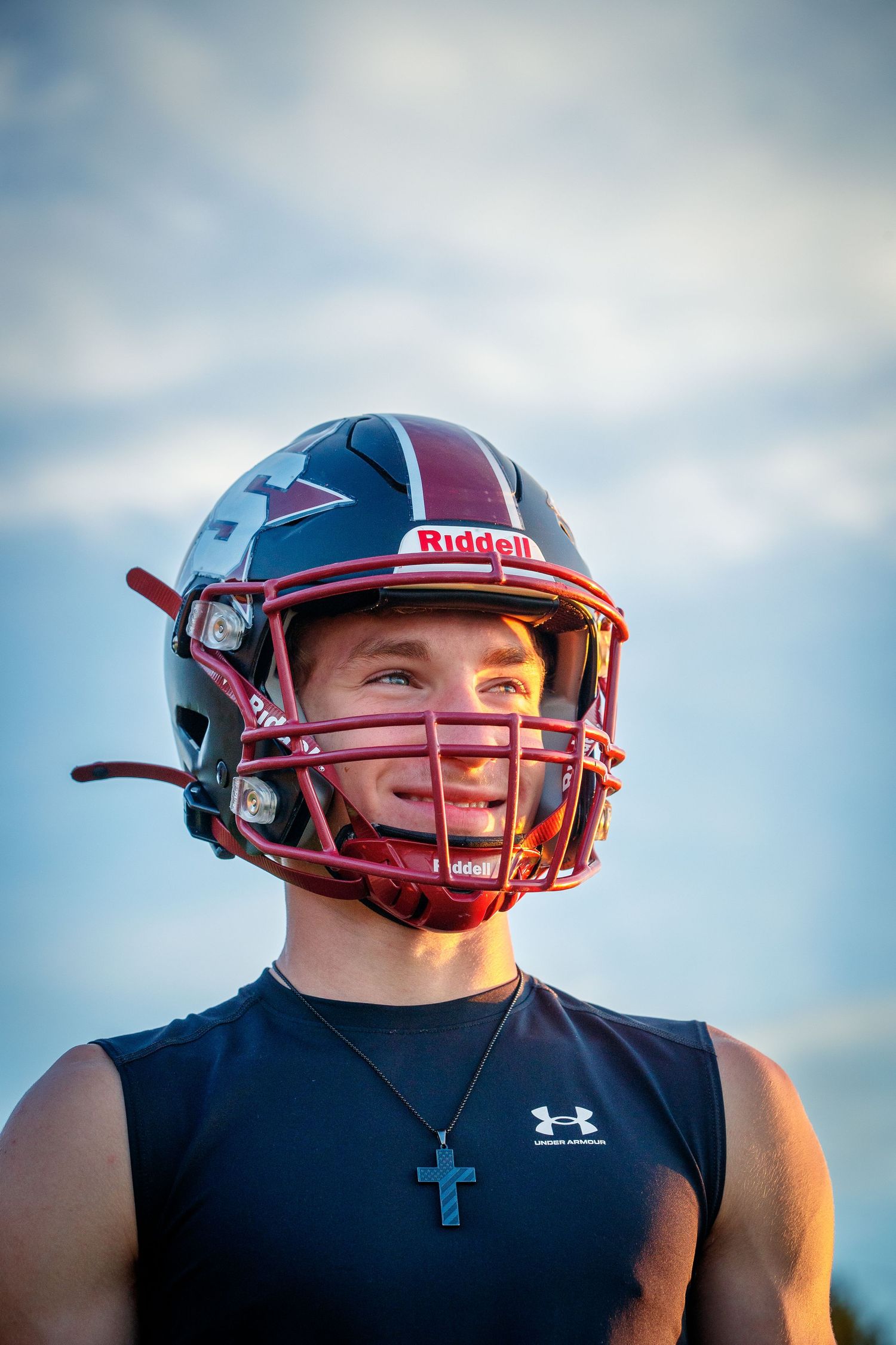 Football player portrait wearing helmet and uniform