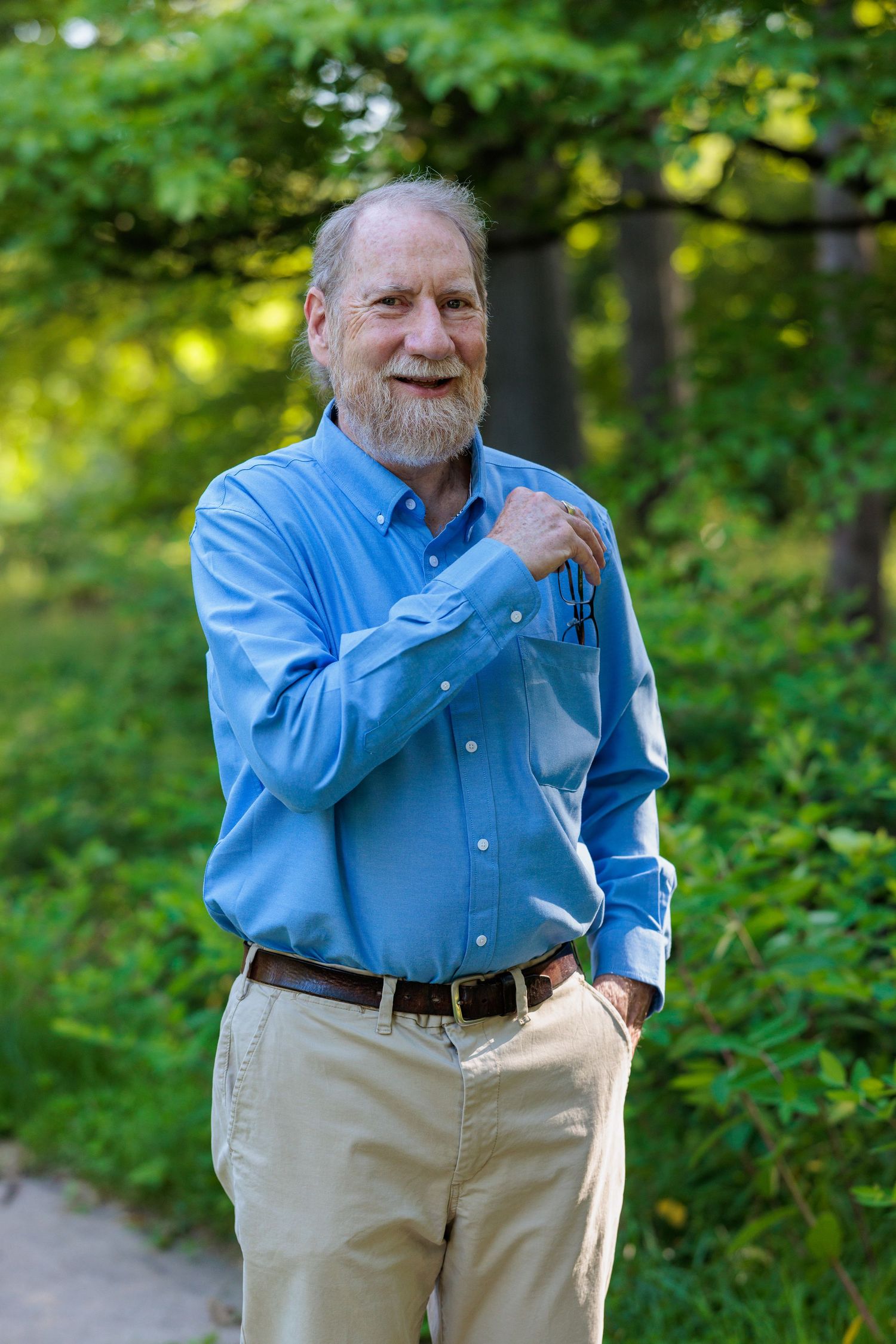 Portrait of Roi Qualls standing outdoors in greenery, co-author of Points of Failure Vol. 1: Interwoven