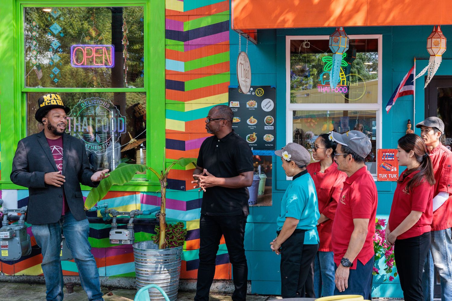 Mayor speaking with Tik's Thai owner and staff outside the colorful exterior on Dayton Street Yellow Springs Ohio