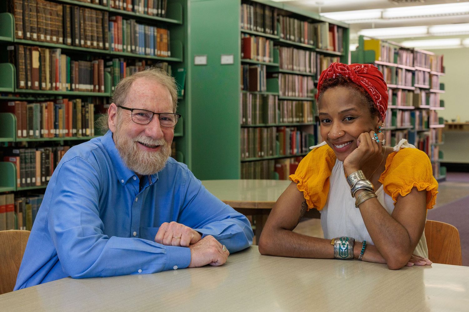 Roi and Hyacinth seated together at a table in the Antioch College library
