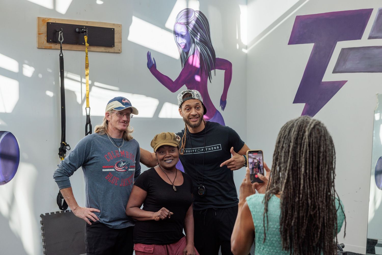 Kyle Truitt posing with a guests inside the new Truitt Fitness gym.