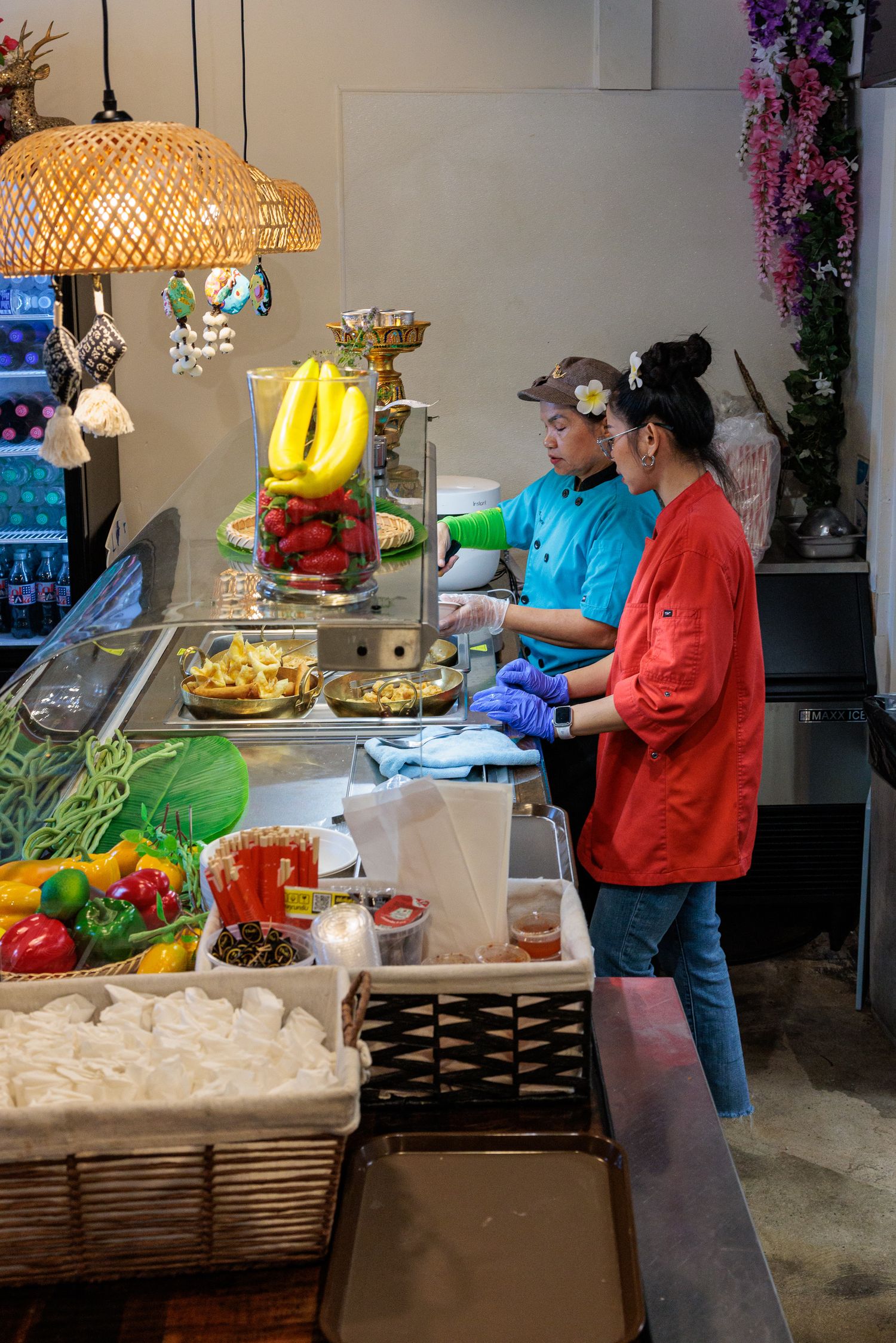 Tik's Thai staff preparing food behind the counter at grand opening Yellow Springs Ohio