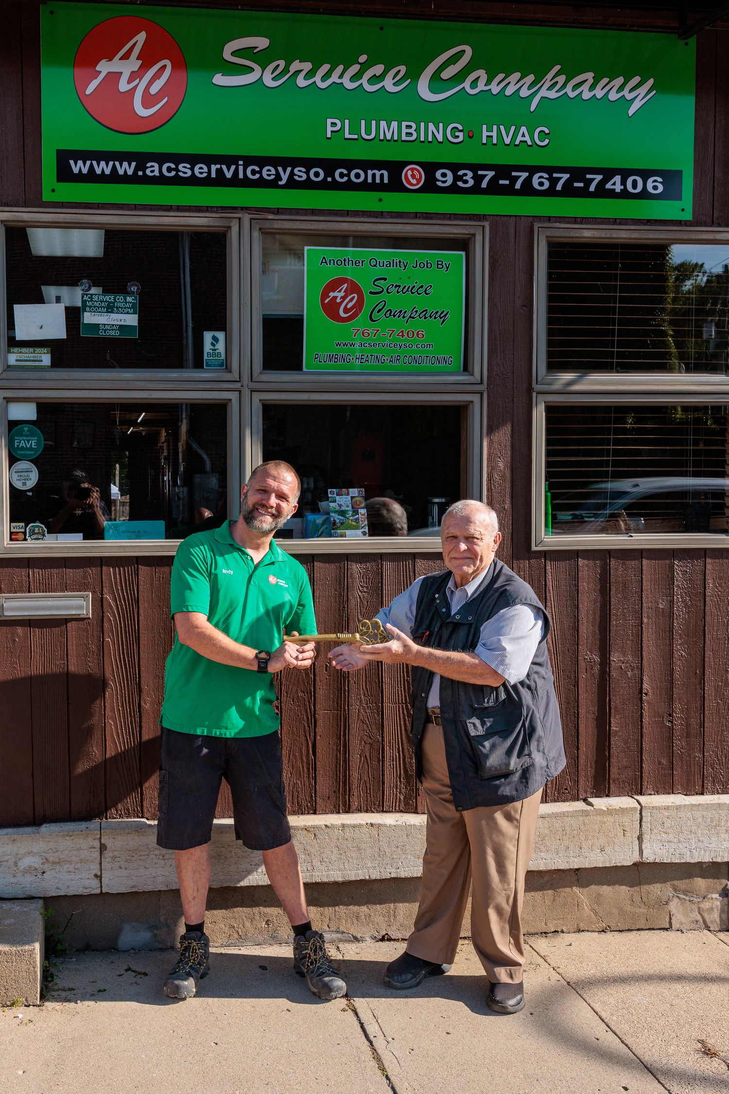 Uncle passing the key to nephew outside AC Service Company Yellow Springs Ohio