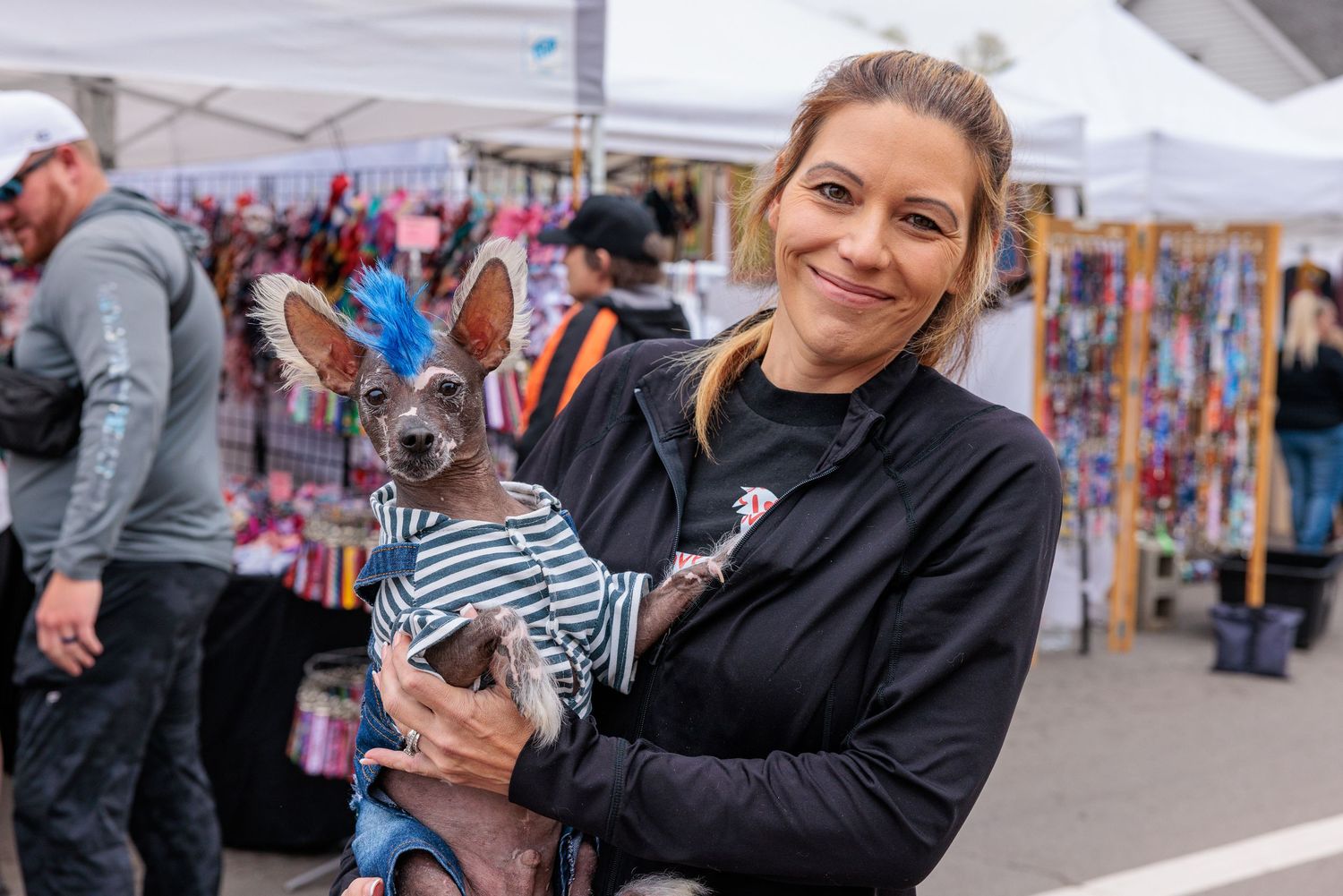 Woman holding her dog at the Sugar Maple Festival dog show in Bellbrook Ohio