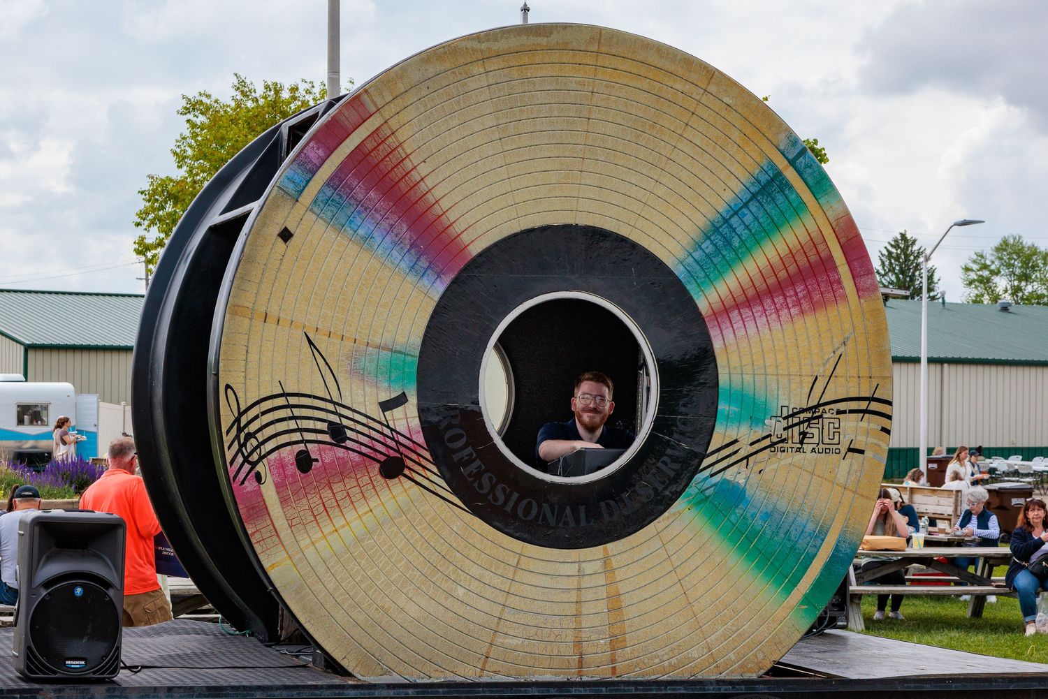 DJ spinning records inside a giant record installation at Vintage Market Days Greene County Fairgrounds