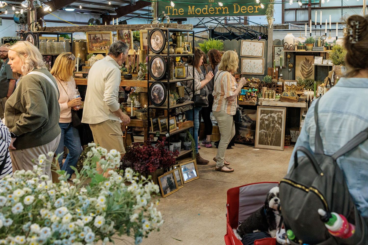 Shoppers browsing vendor booths inside the Vintage Market Days event at the Greene County Fairgrounds