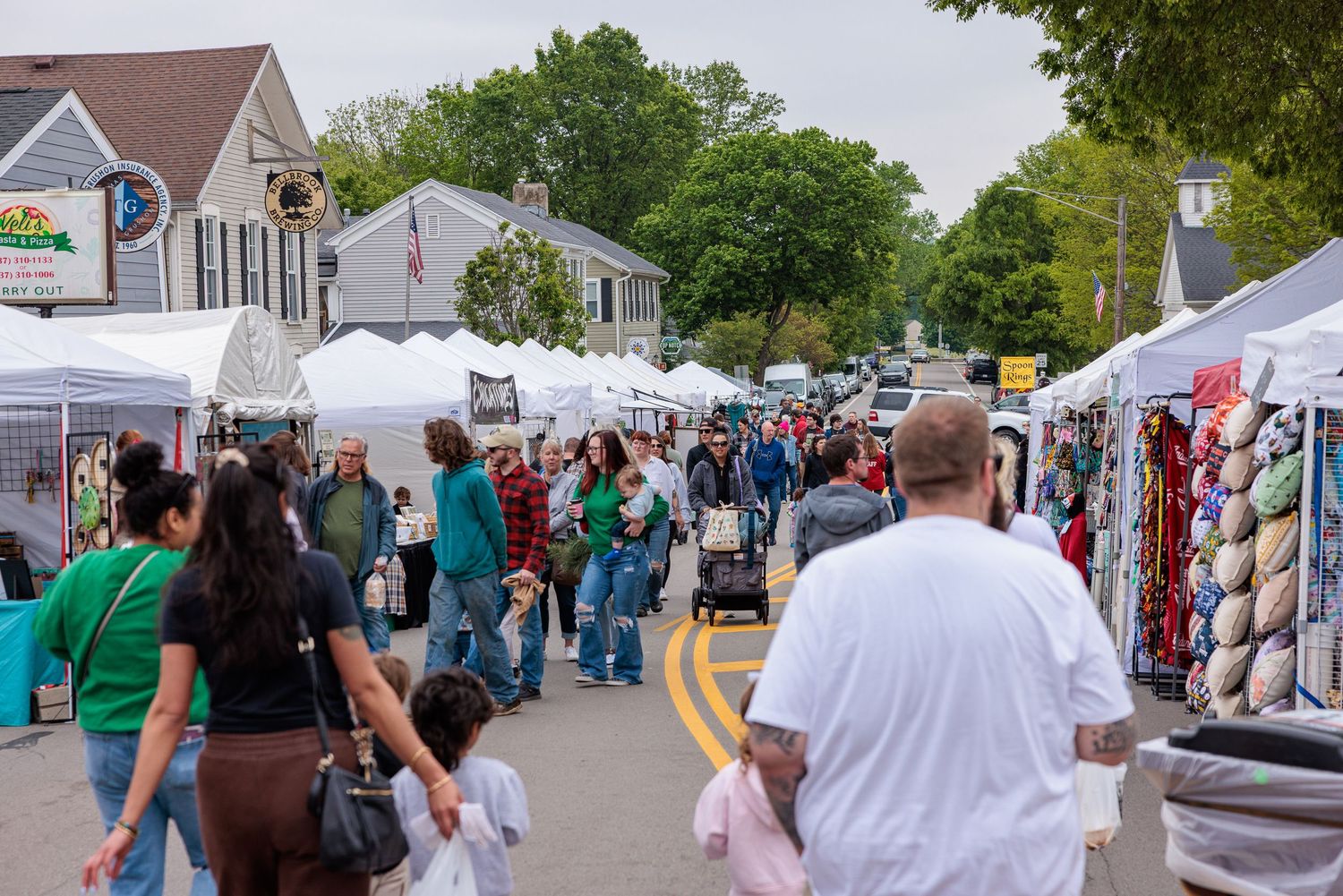 Crowds browsing vendor booths along the street at the Sugar Maple Festival in Bellbrook Ohio