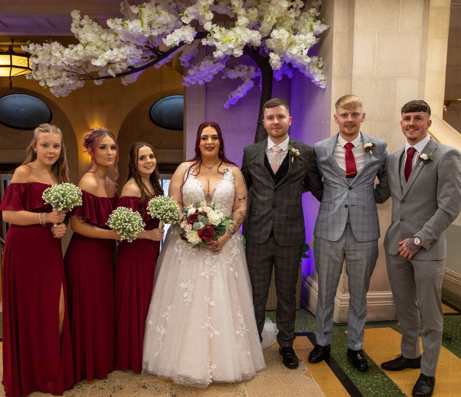 Married couple surrounded by bridesmaids and groomsmen