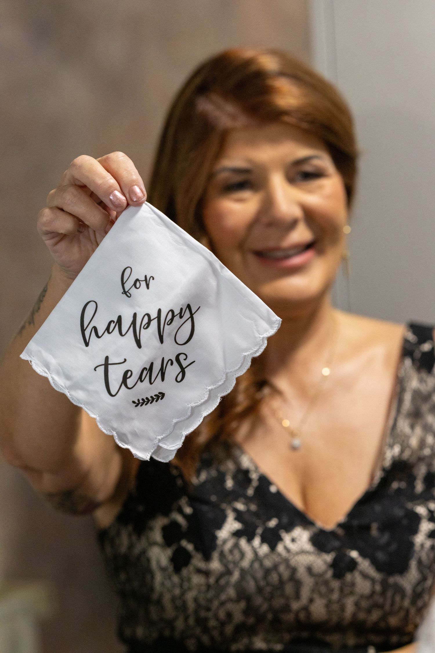 Mother holding napkin with writing for happy tears on it