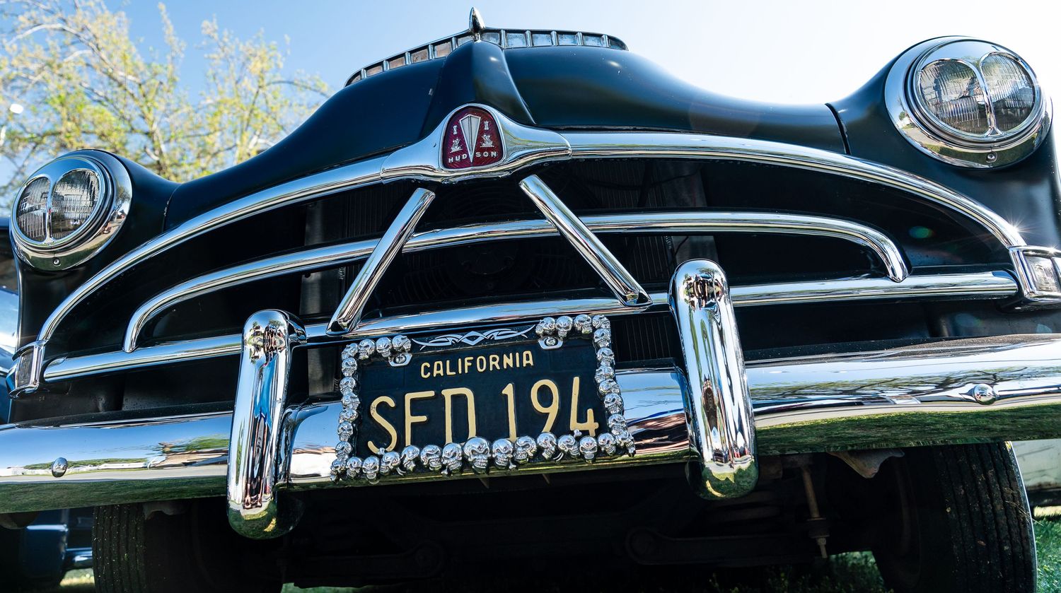 Front view of a classic black car with a California license plate reading SFD 194.