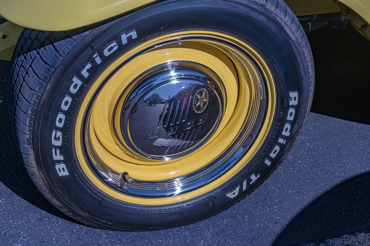 BFGoodrich Radial T/A tire on a gold classic car wheel with chrome hubcap detail.