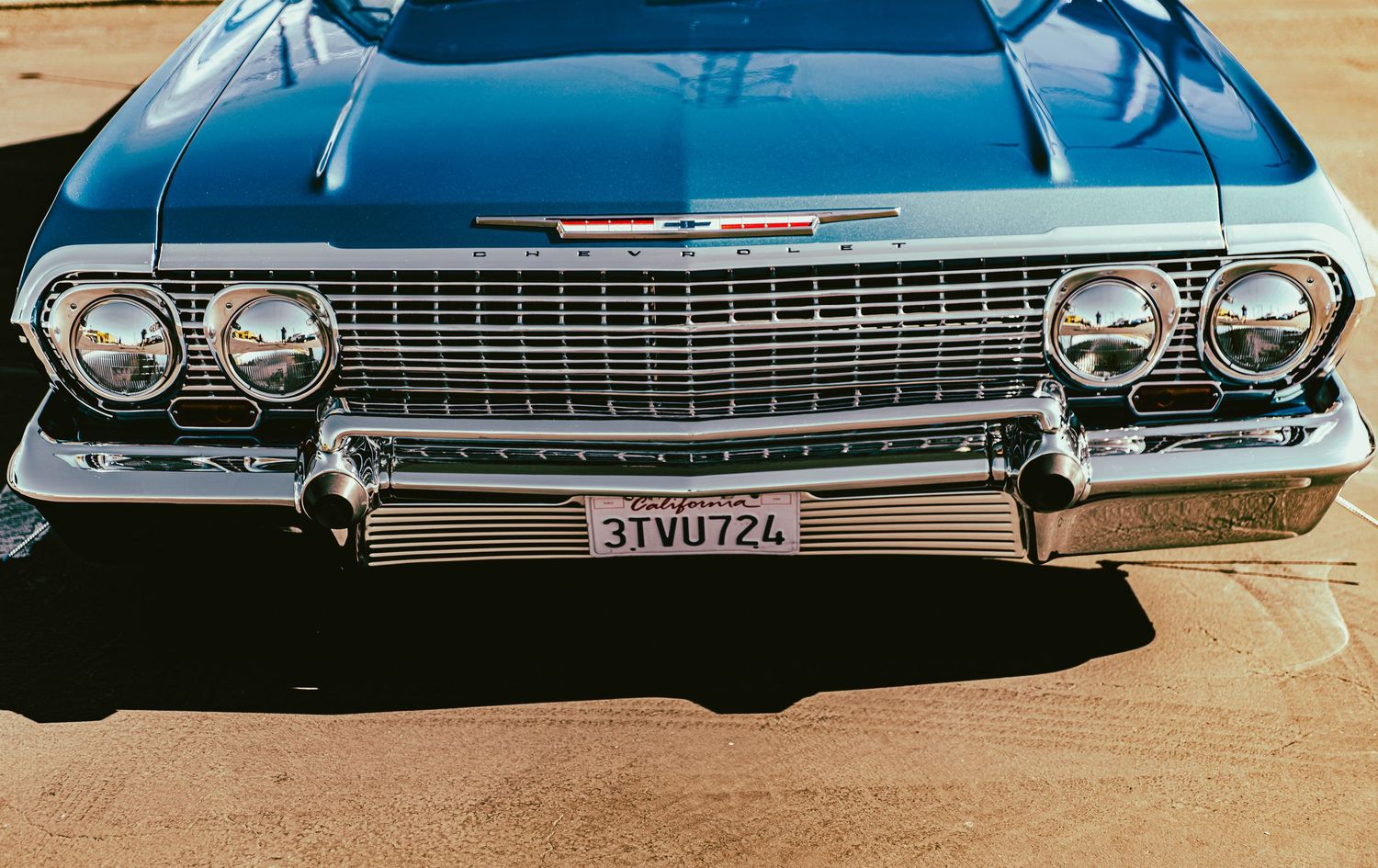 Classic blue 1963 Chevrolet Impala front grille with chrome details and California license plate 3TVU724.