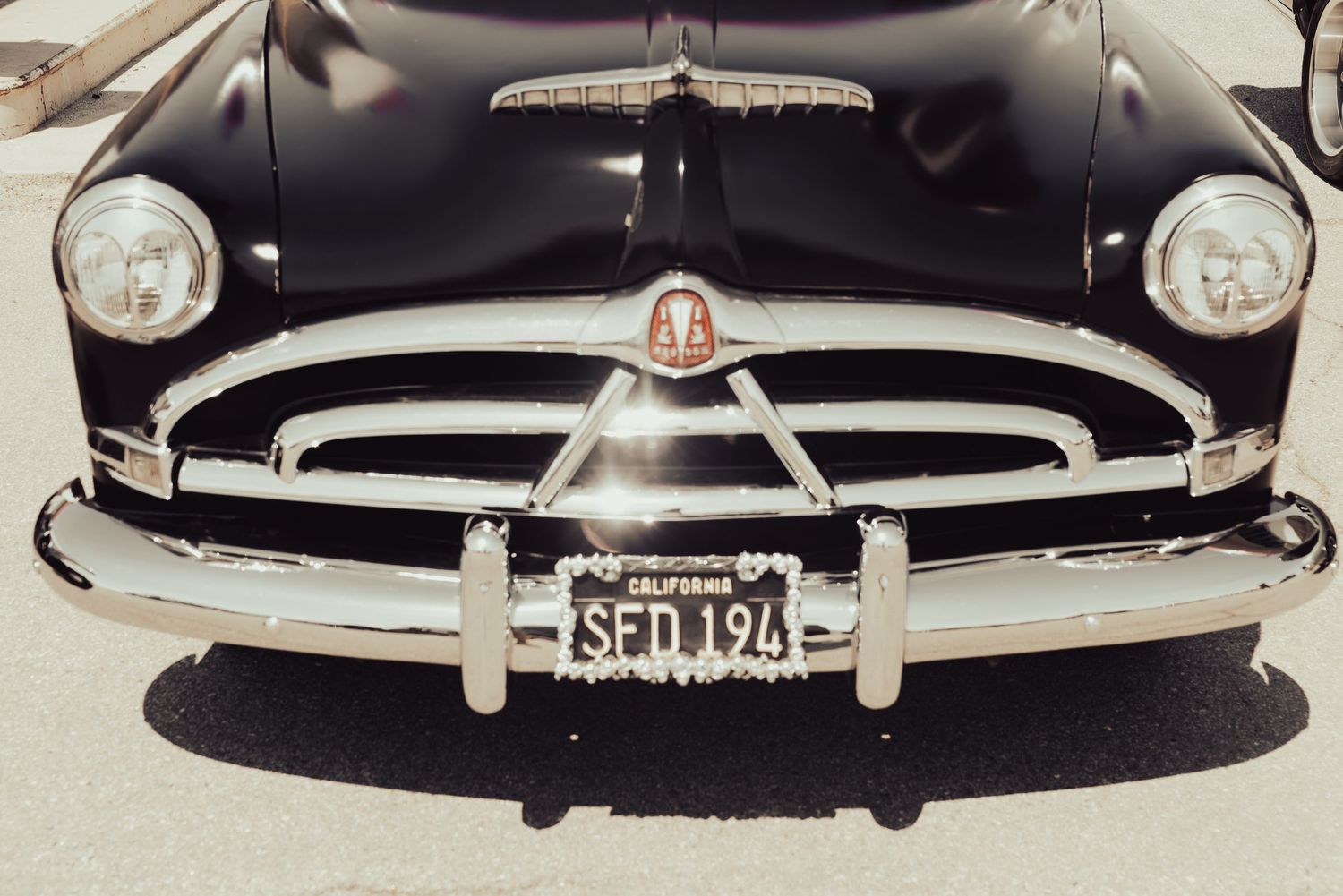 Vintage black classic car with chrome grille and California license plate SFD 194 photographed from the front.