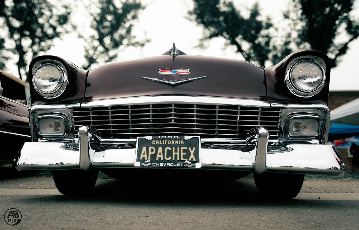 Front view of a classic 1956 Chevrolet with chrome grille and California plate APACHEX.