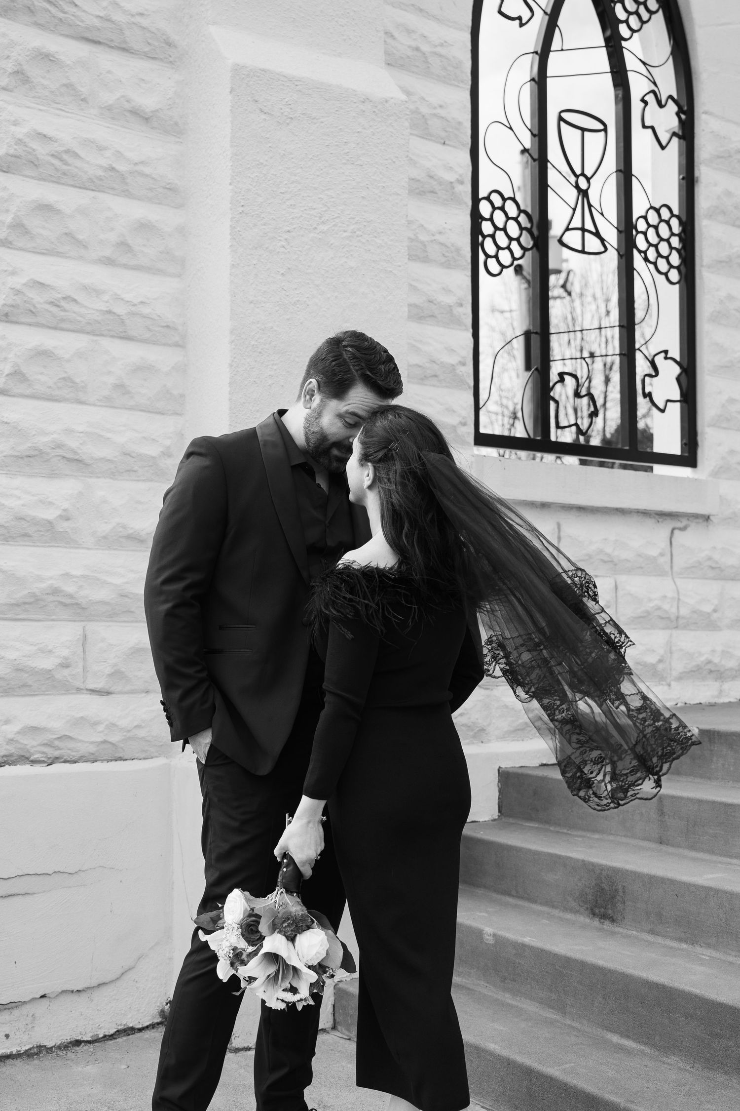 ©AnnaVonRiesenPhotography Wedding Ceremony Portrait | Image of a couple holding eachother and smiling.