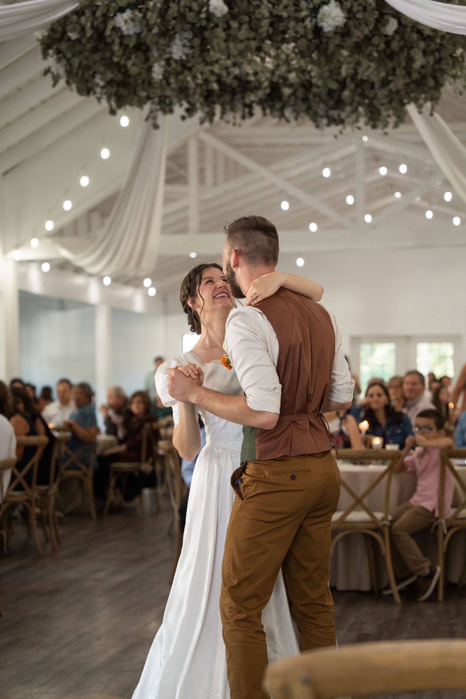 ©AnnaVonRiesenPhotography Wedding Reception Photography | Image of bride and groom dancing and smiling at each other.