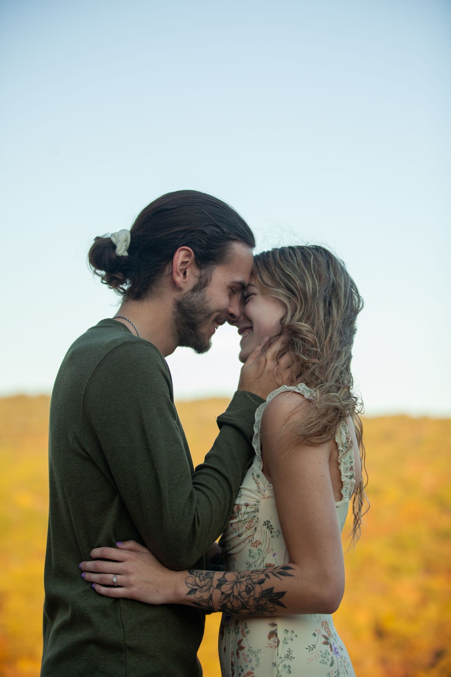 ©AnnaVonRiesenPhotography Engagement Portraits | Image of a couple touching foreheads and smiling.