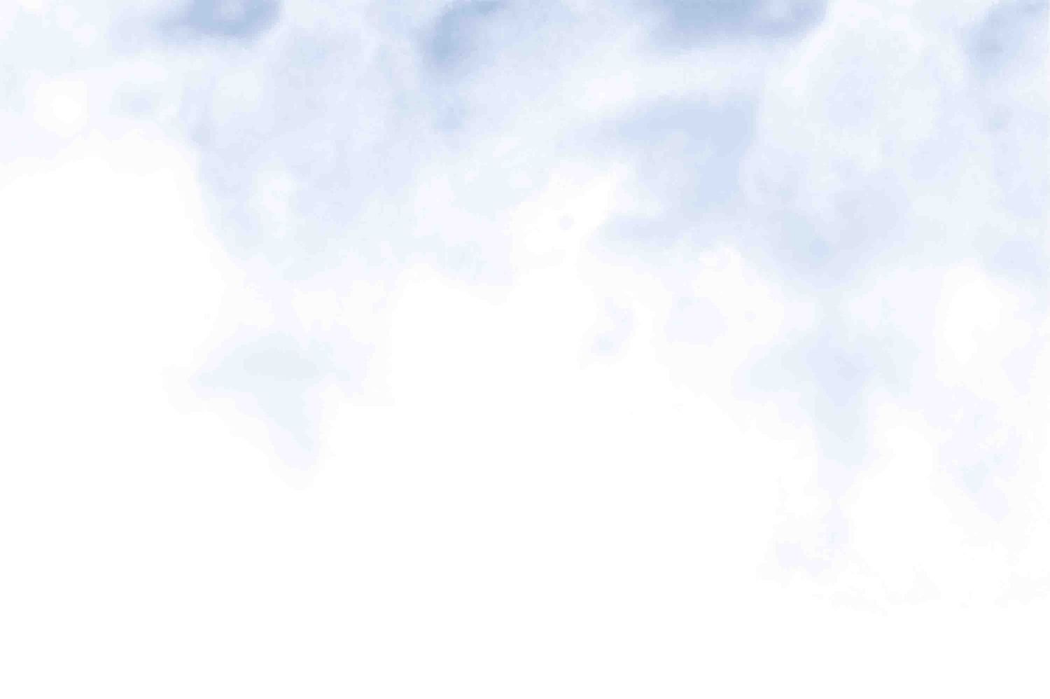 A blurry cloudy sky with soft white and light blue tones creates an ethereal atmospheric background.