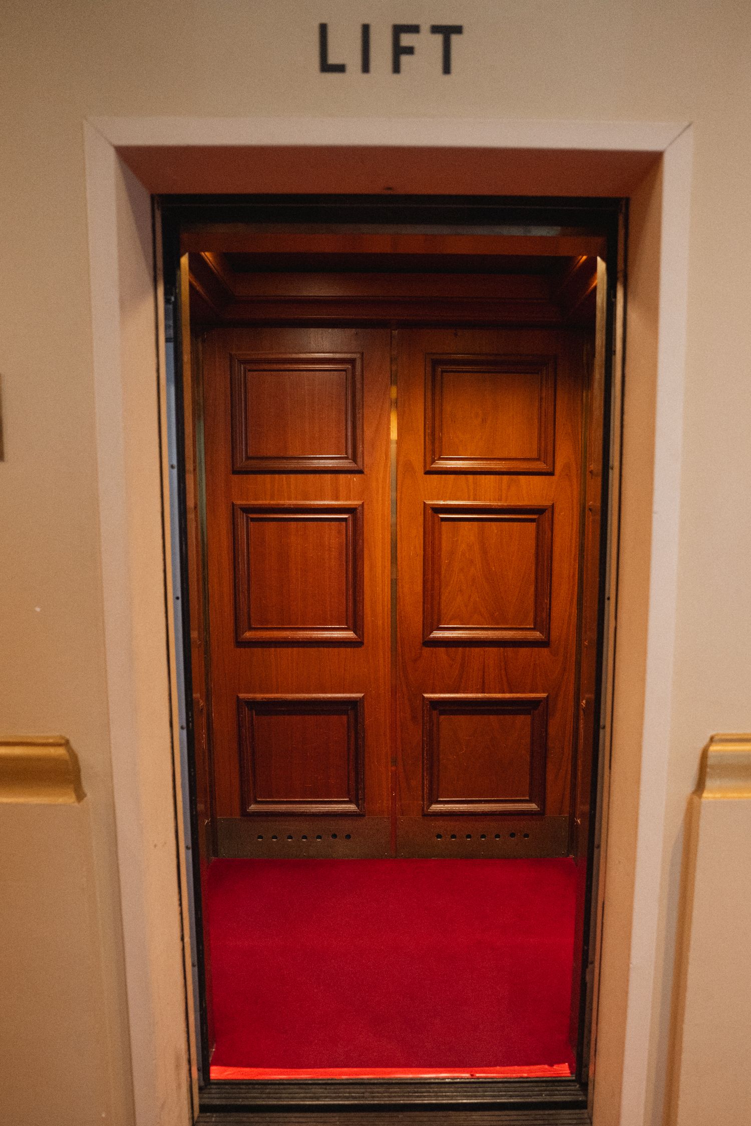 Series of photos showing wooden door slowly closing with red cushioned bench visible underneath.