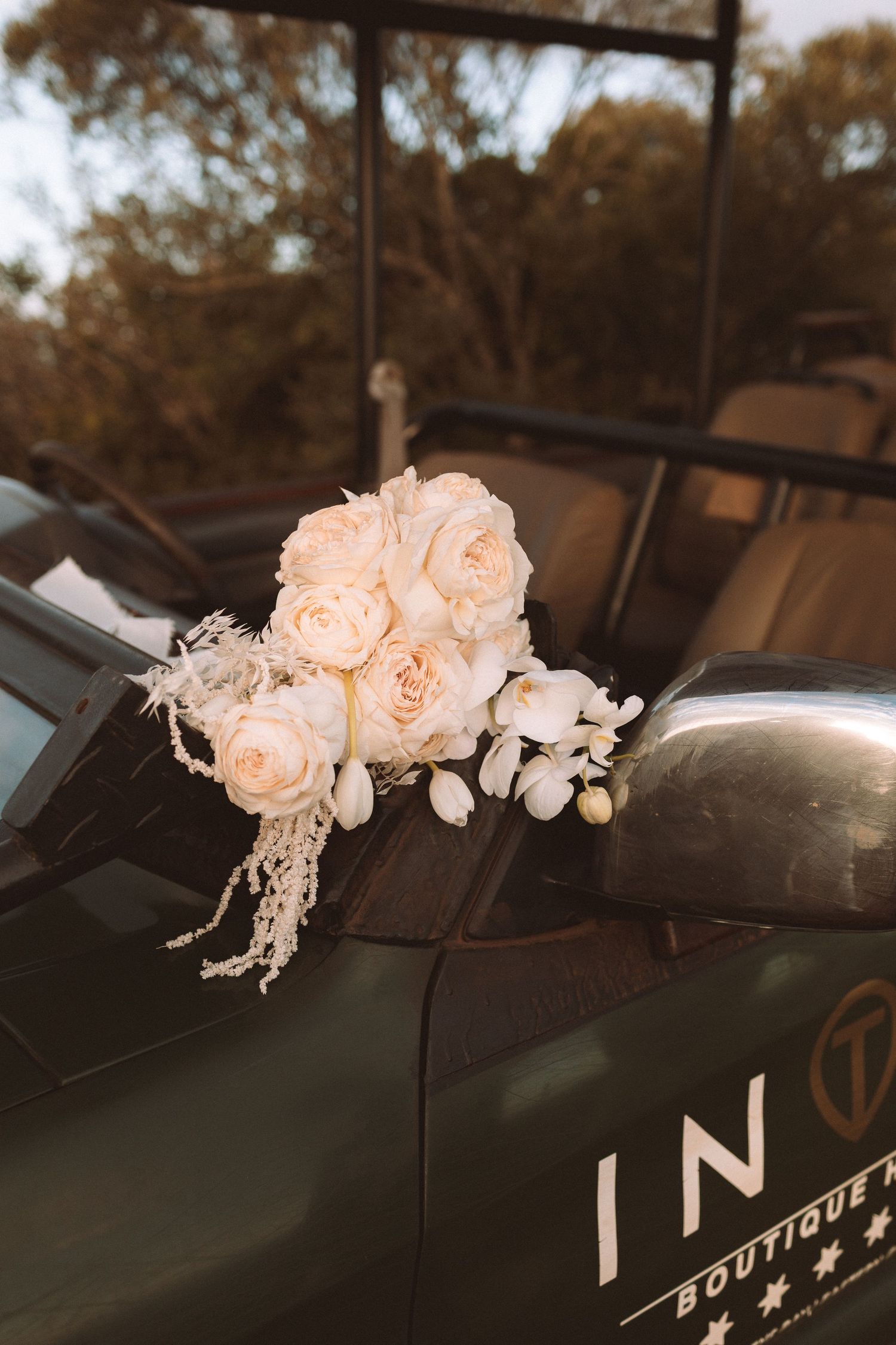 Peach roses and white floral decorations arranged elegantly on a dark car dashboard in a series of connected photos.