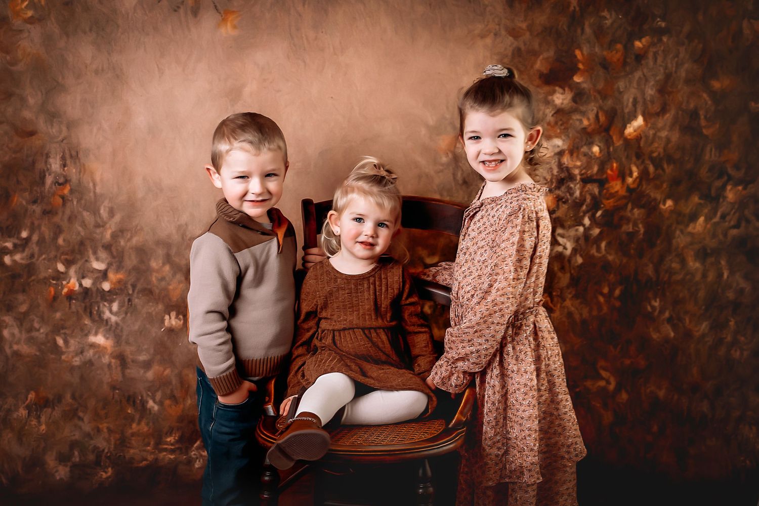 Rustic fall family portrait session against textured brown backdrop with warm autumn tones and vintage bench, Near Plymouth, WI