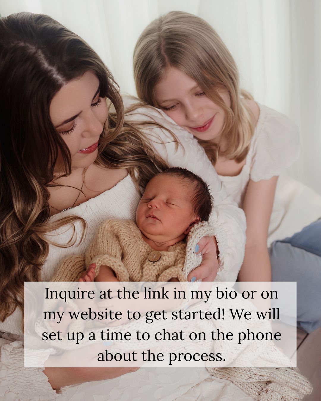 A mother and older daughter lovingly gaze at a newborn baby wrapped in a knit blanket during a family photo session.