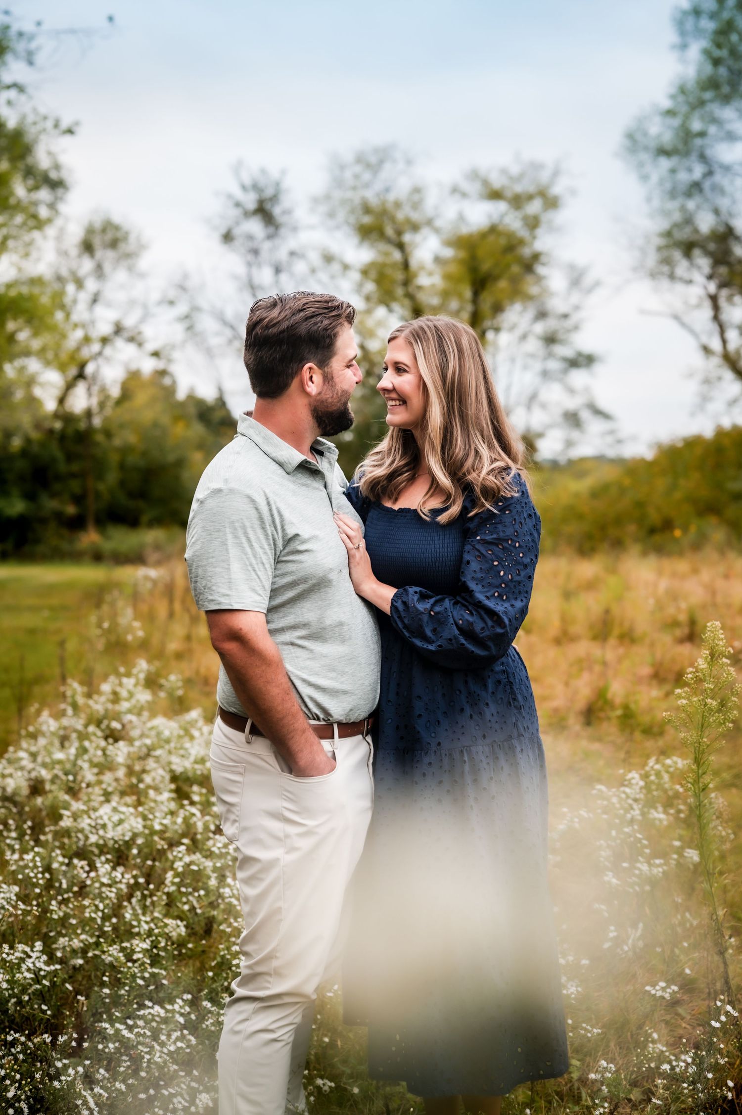 A couple shares a romantic moment together in a wildflower meadow during a sunny autumn day near Slinger, WI