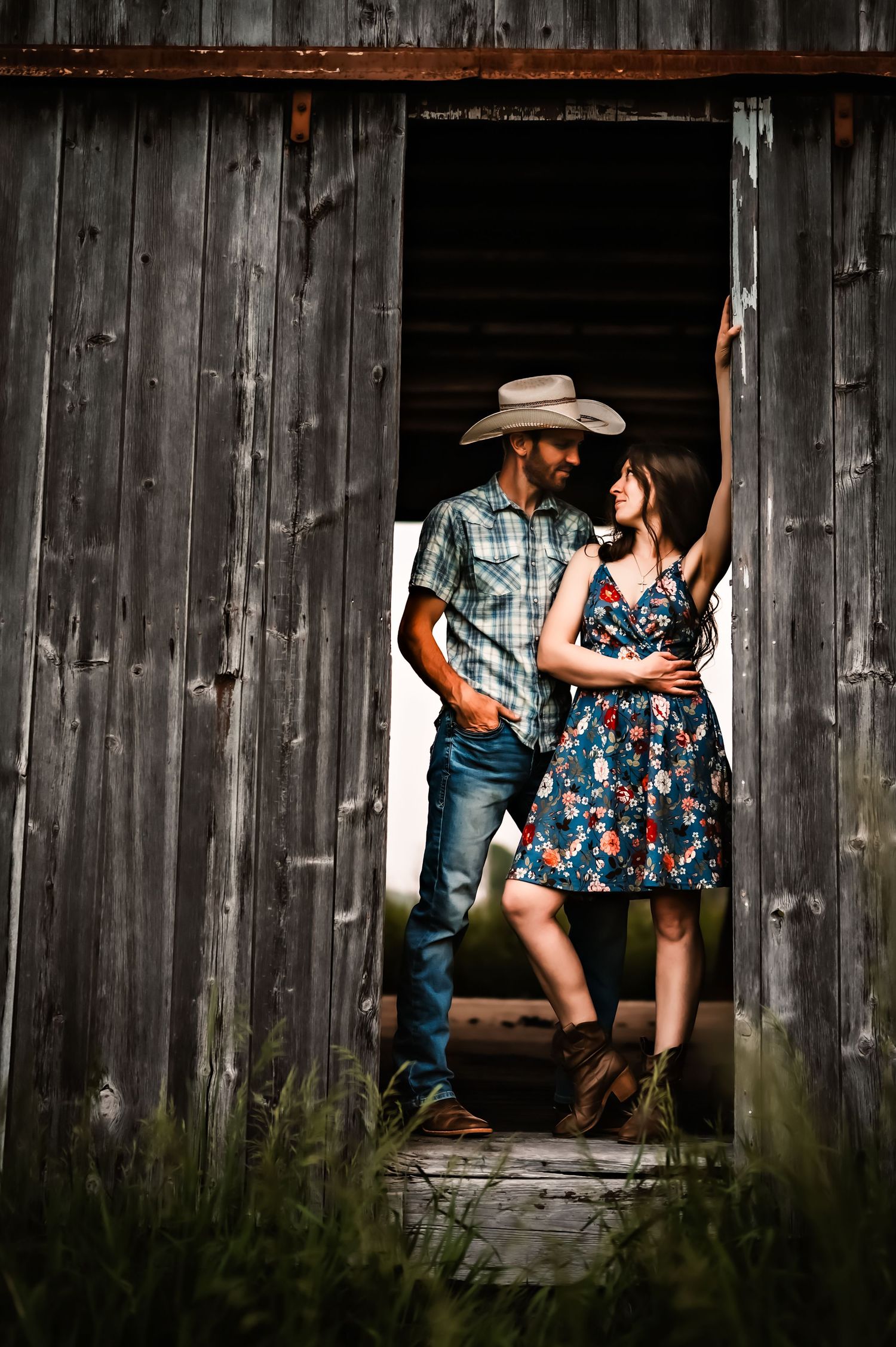 Rustic engagement photos against weathered barn wood with vintage country styling.