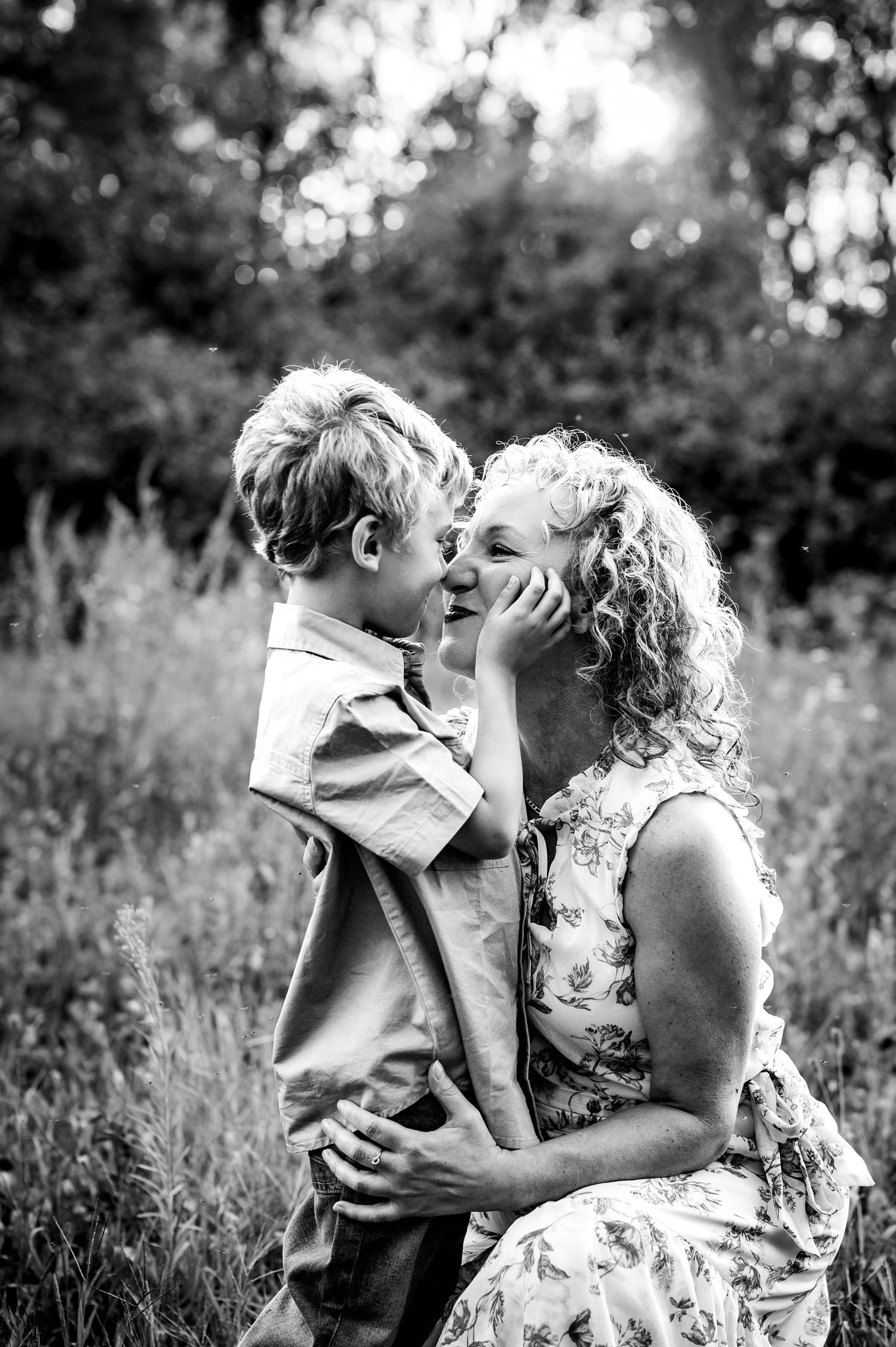 Black and white portrait of tender moment in summer meadow.