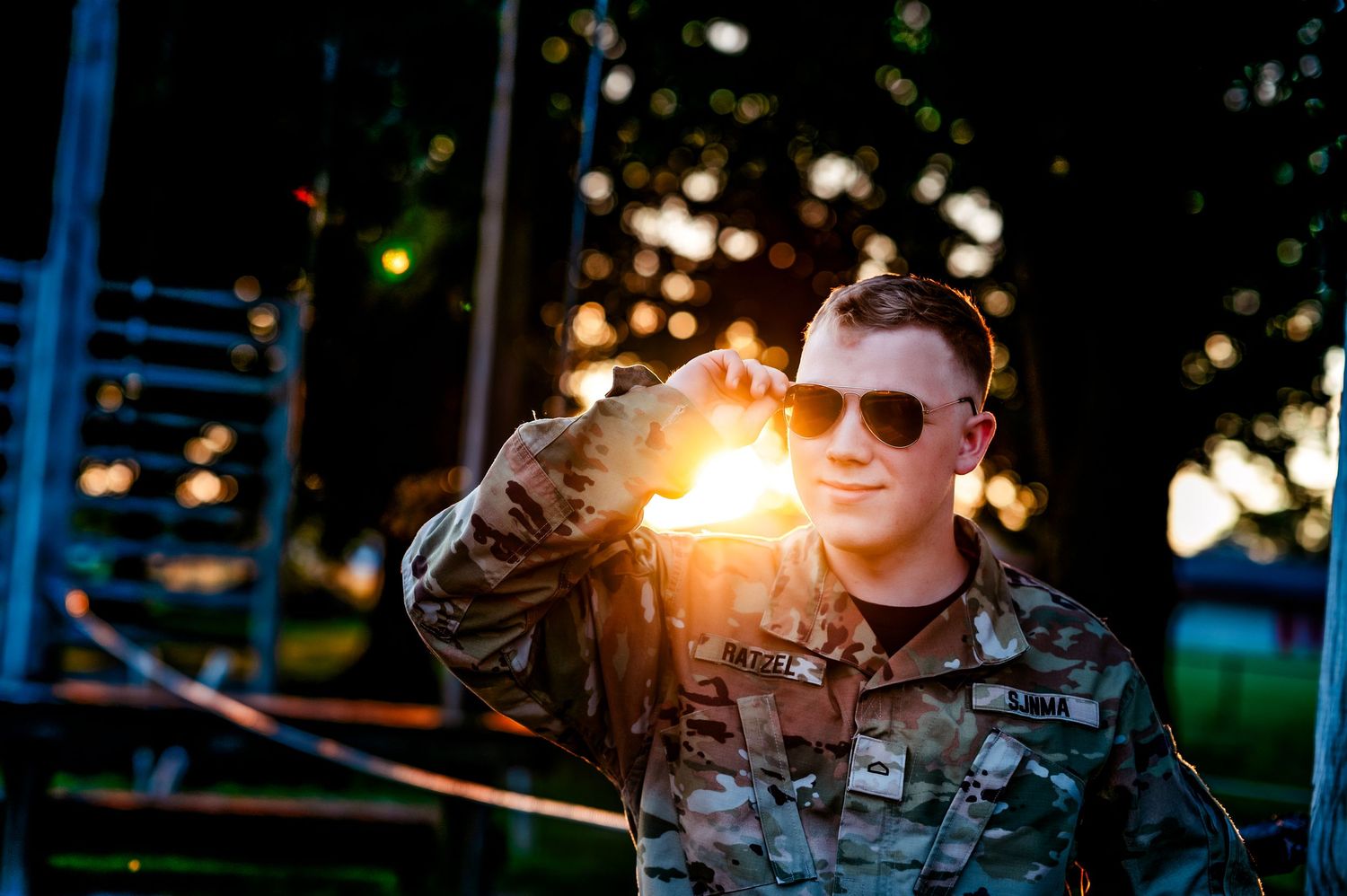Military personnel in tactical gear and sunglasses conduct training exercises at dusk with glowing lights visible near Milwaukee, WI