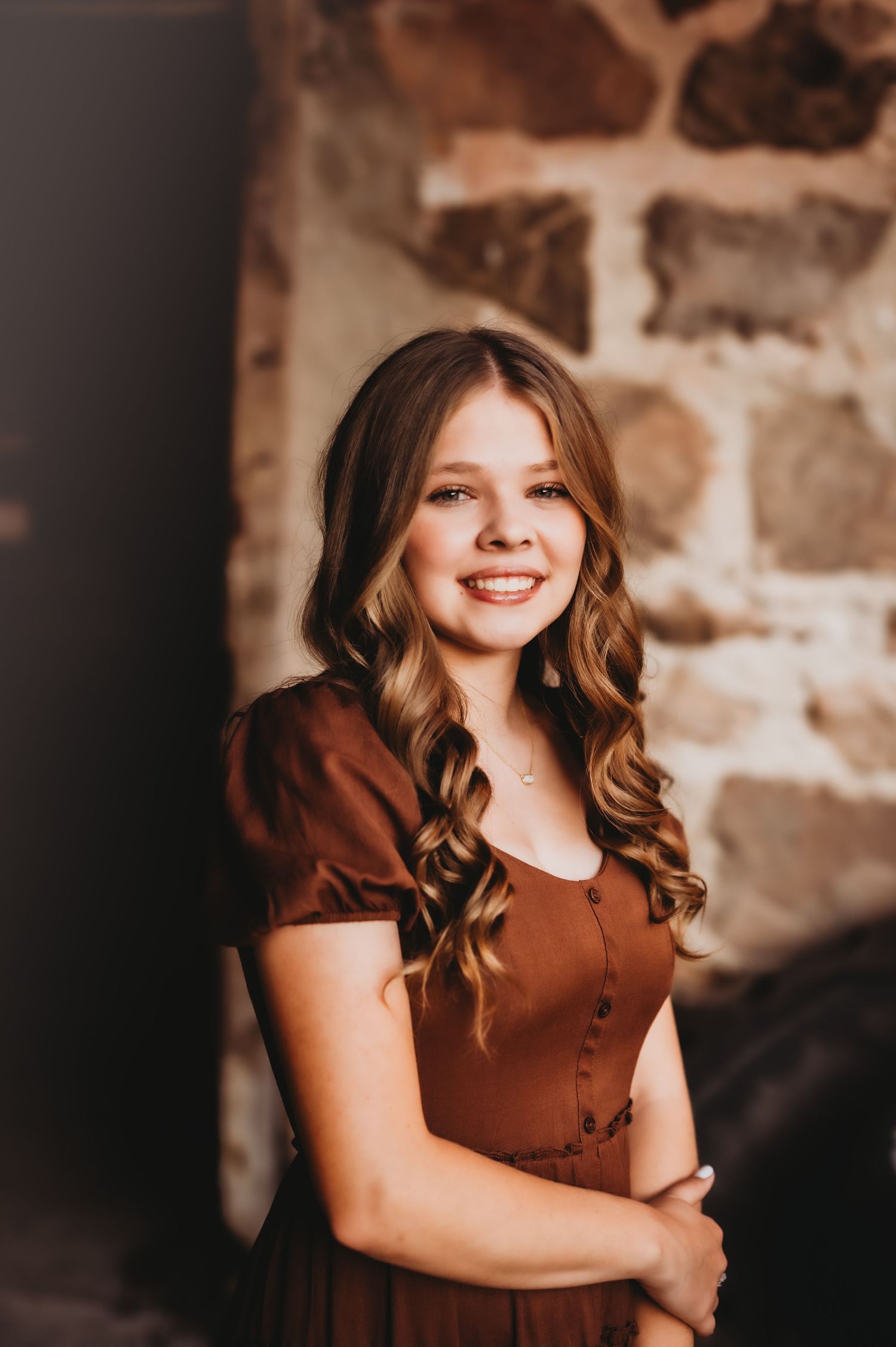 A series of five portrait photos in warm brown tones against a textured wall background. West bend, WI