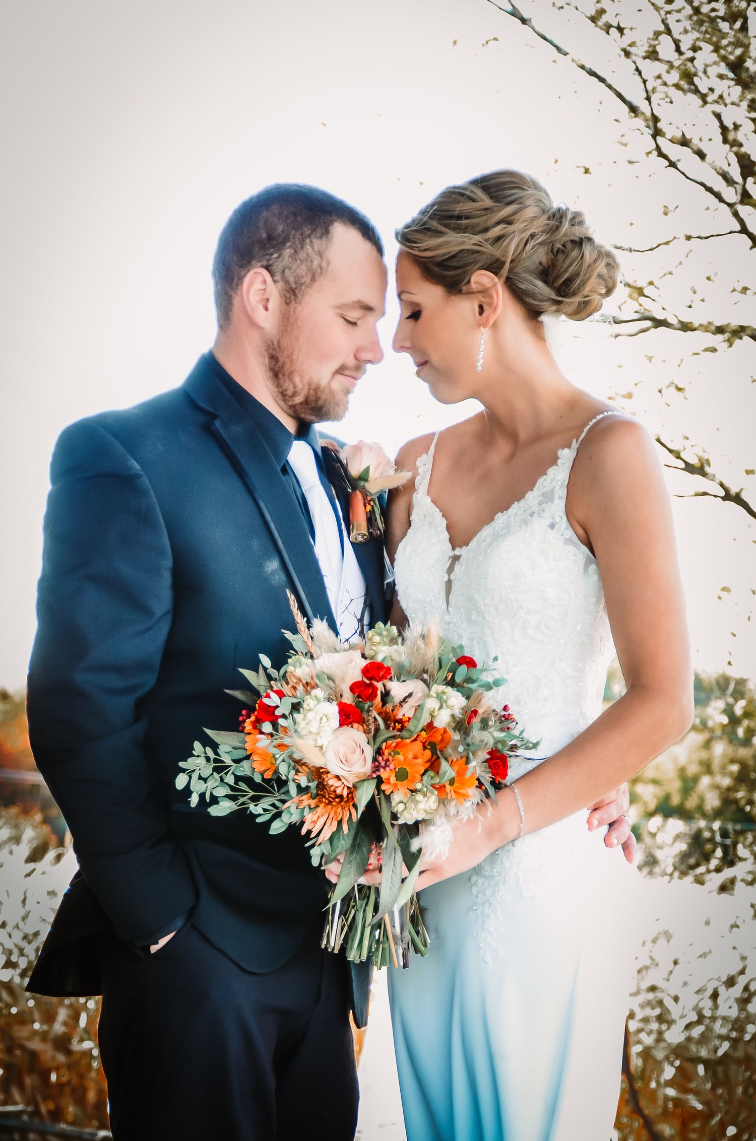 Winter wedding couple shares intimate moment with vibrant floral bouquet.