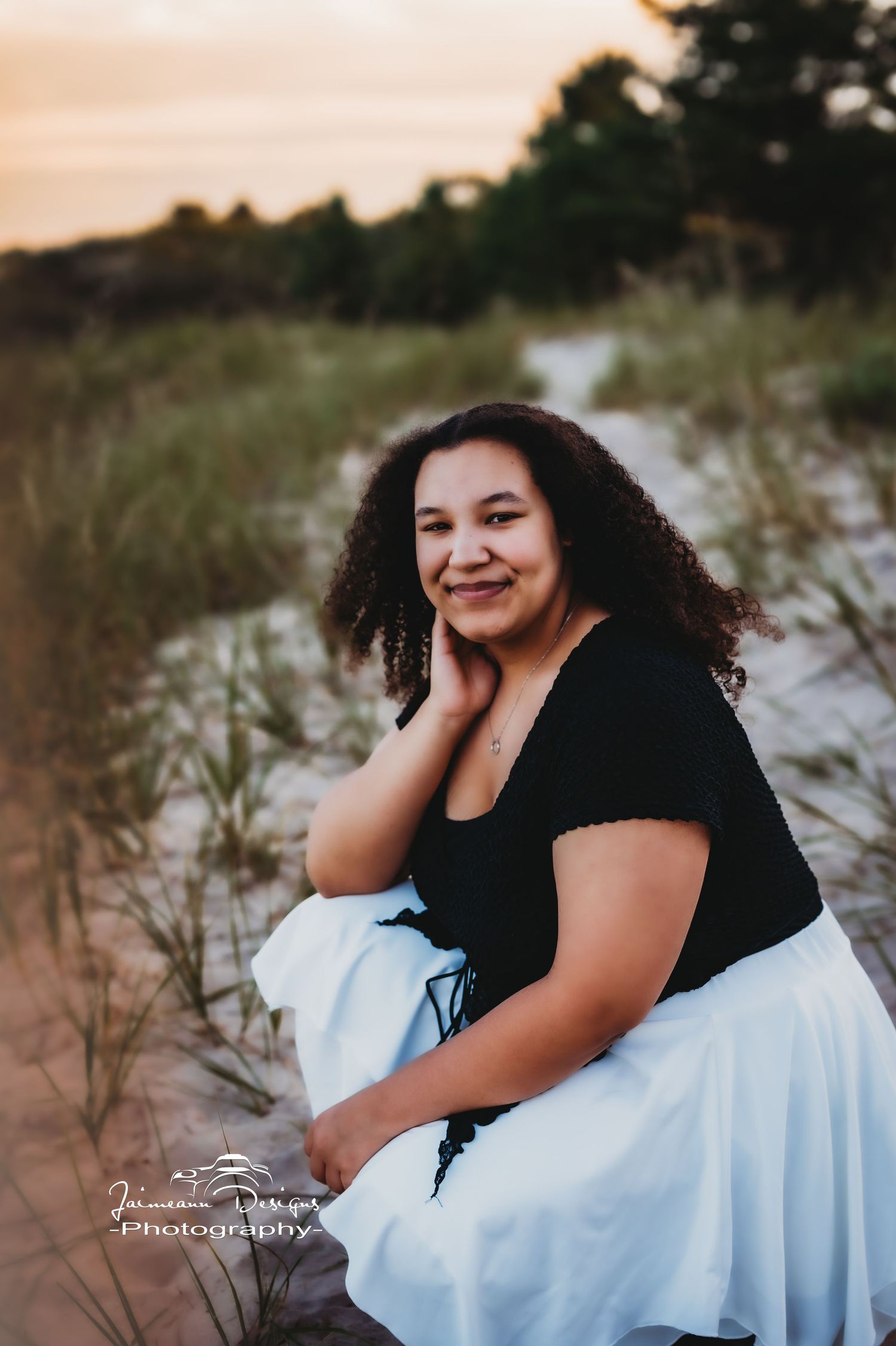A beautiful sunset portrait session in a natural beach setting with flowing white skirt.