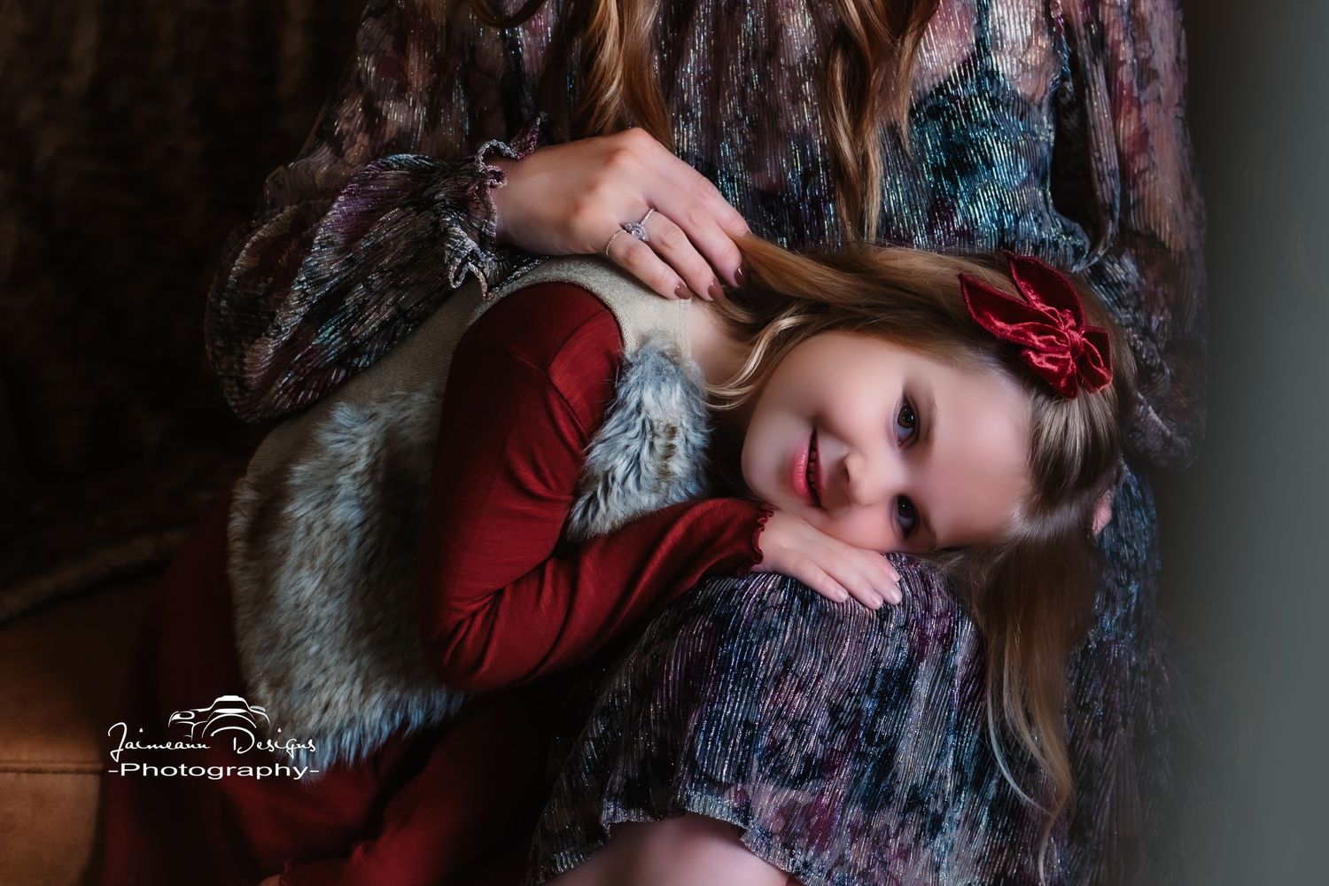 Artistic portrait with red dress and floral elements in moody lighting.