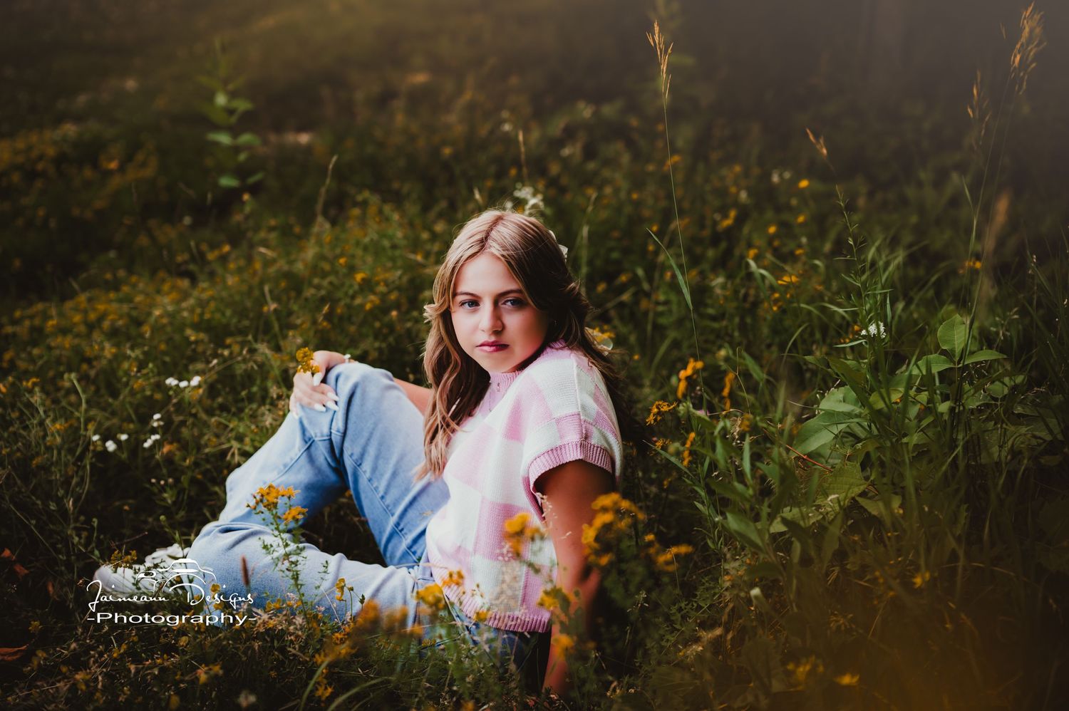 A casual outdoor portrait in a field with tall grass and natural lighting.