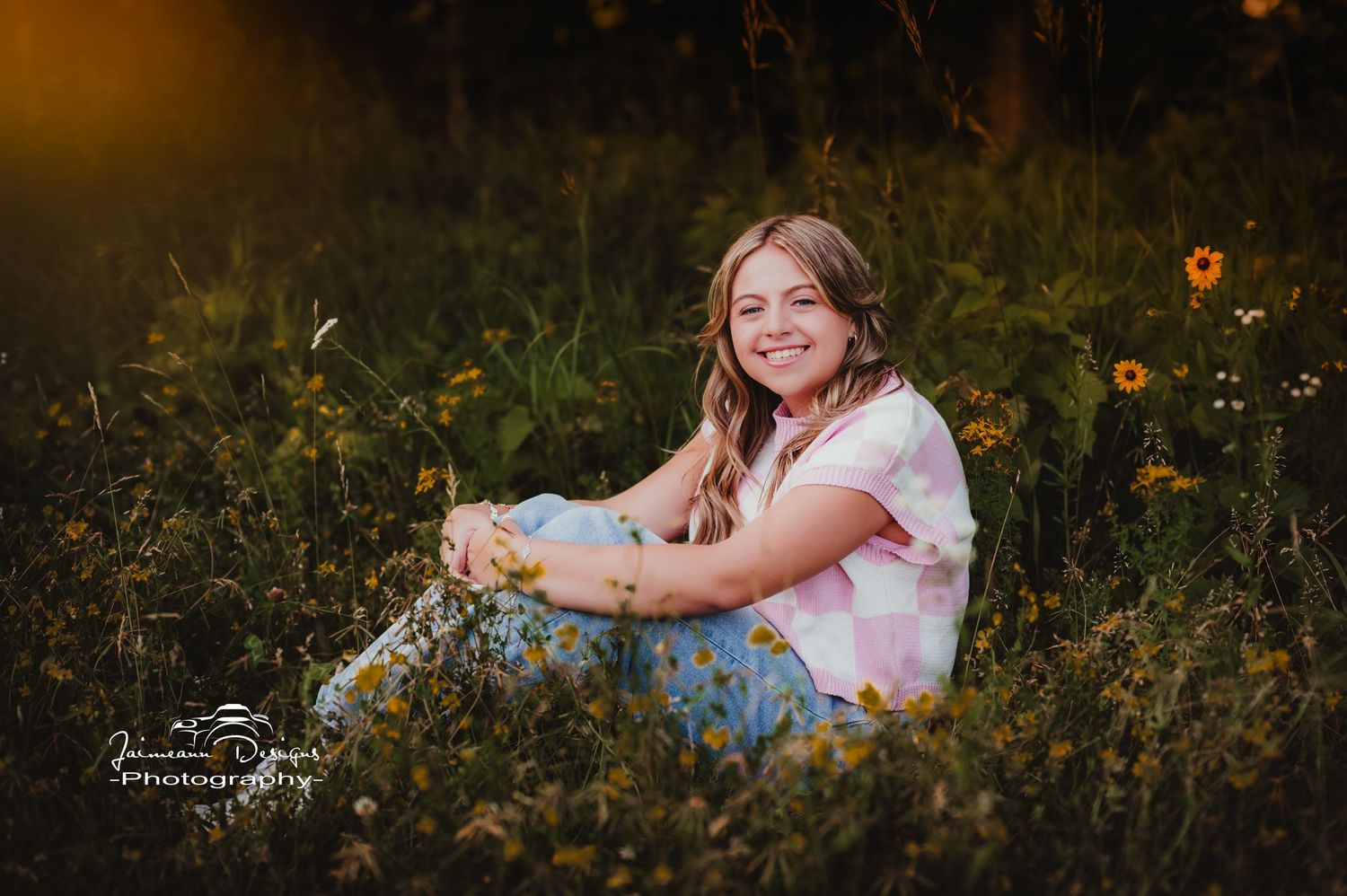 Sitting in blooming wildflower field during golden hour sunset.