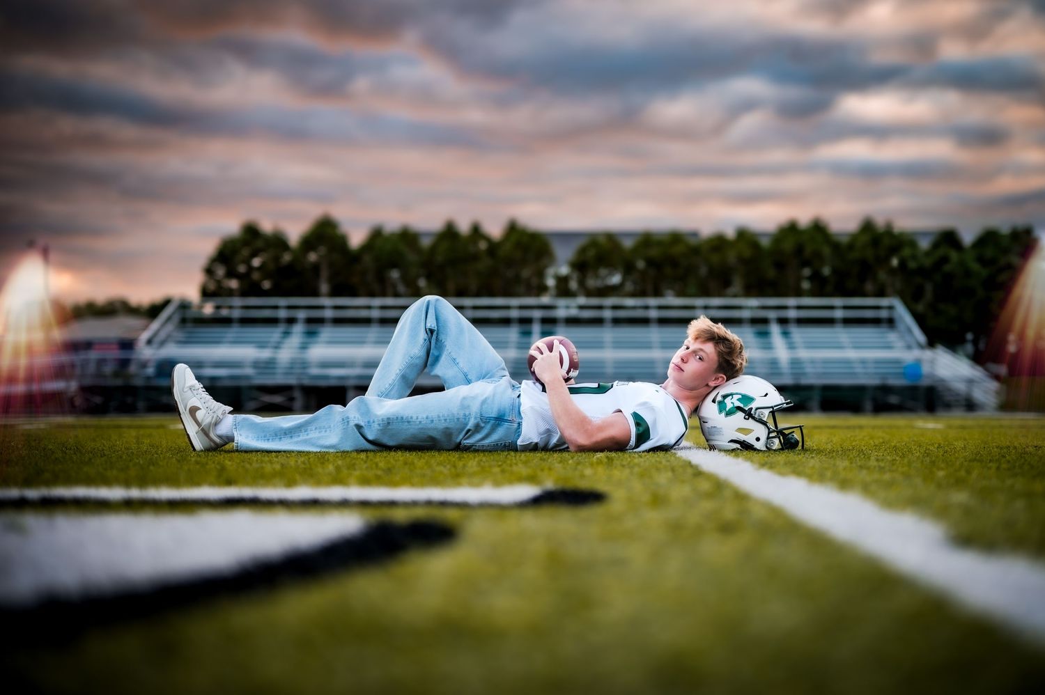 Foot Ball Field Posing with sunset and foot ball on Kewaskum High School Foot ball Field, WI