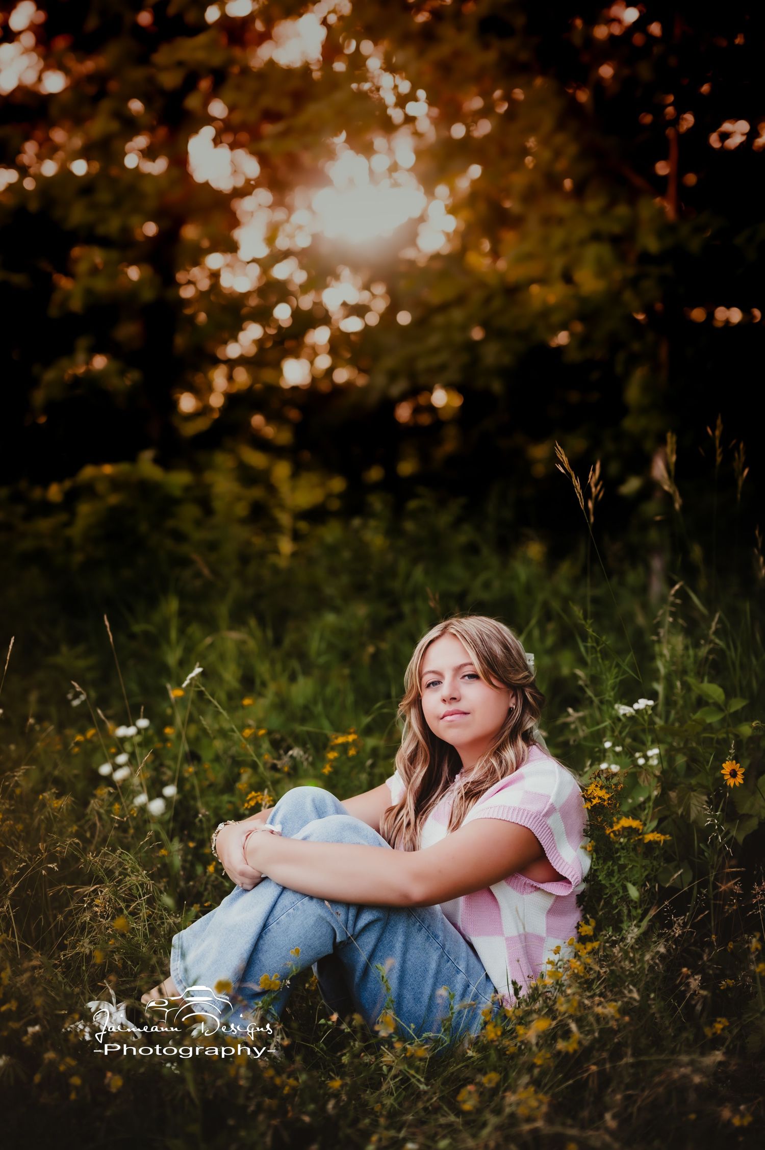 Dreamy sunset portrait in meadow with golden bokeh lighting.