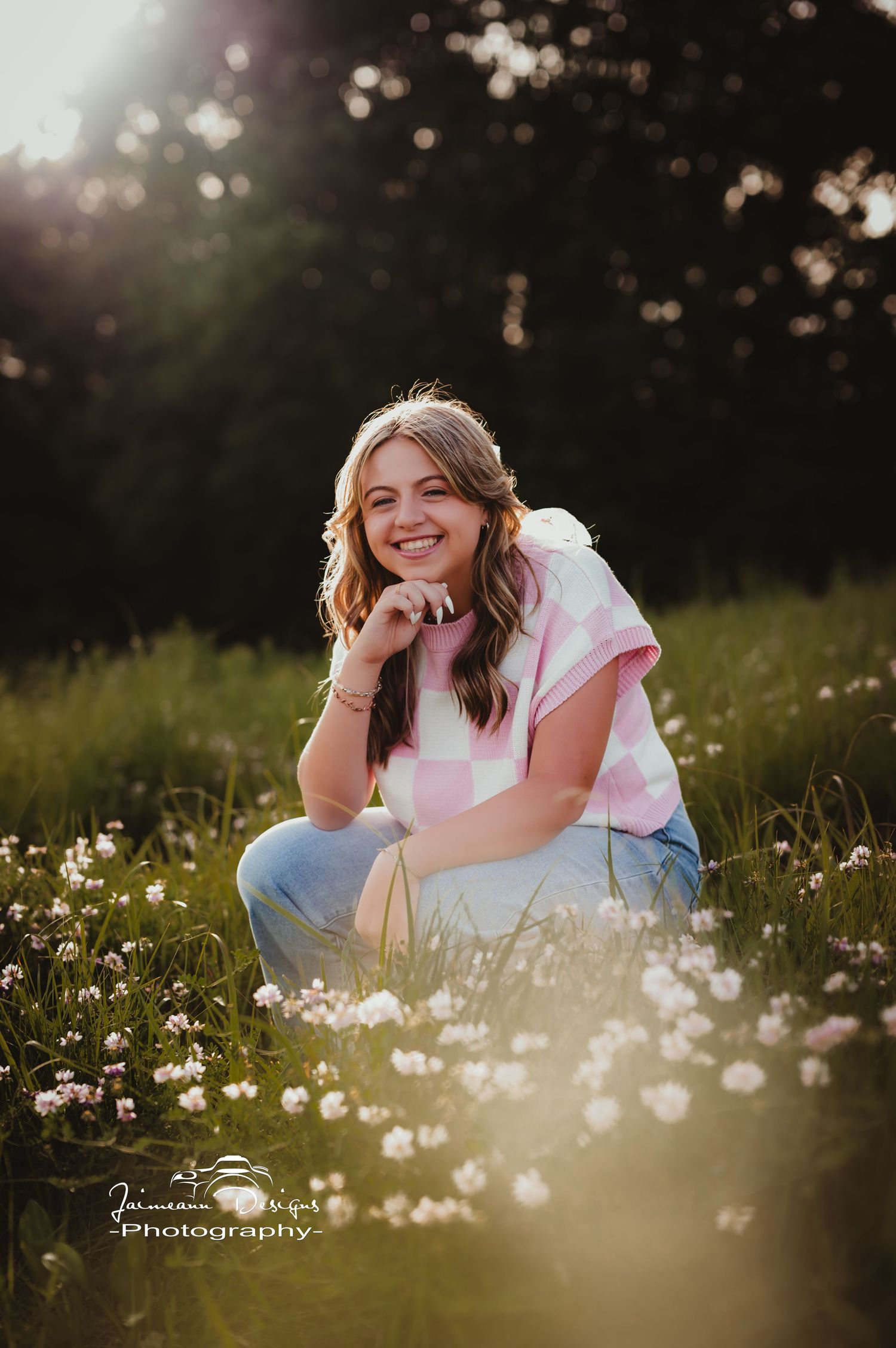 Casual outdoor photoshoot among white wildflowers at sunset.