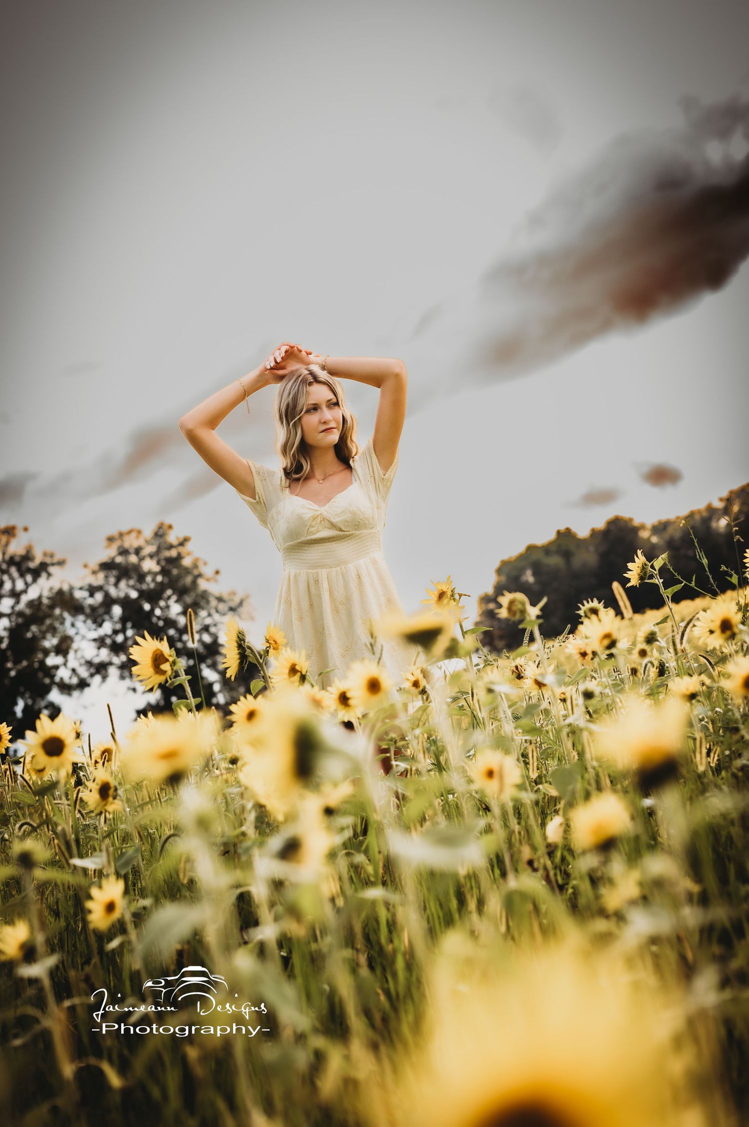 Romantic summer photoshoot in field of blooming sunflowers during golden hour.