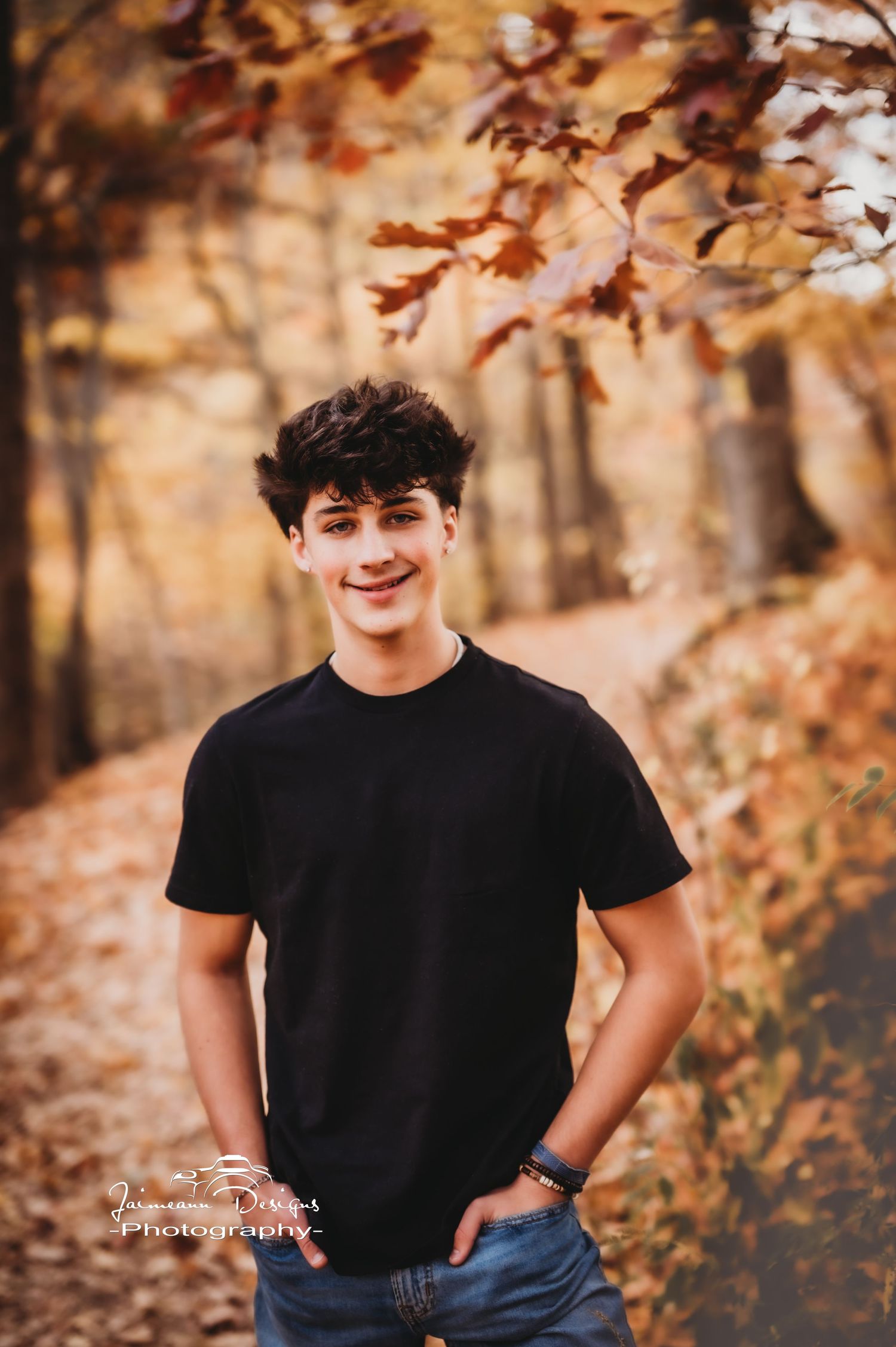 Outdoor portrait with golden autumn trees and black t-shirt casual style.
