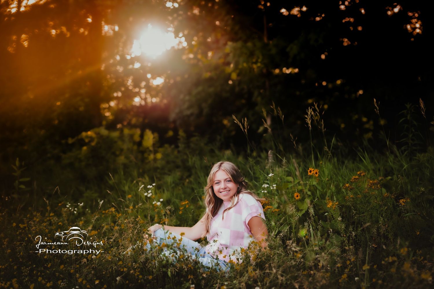 Sunset portrait session in field of tall grass and wildflowers.