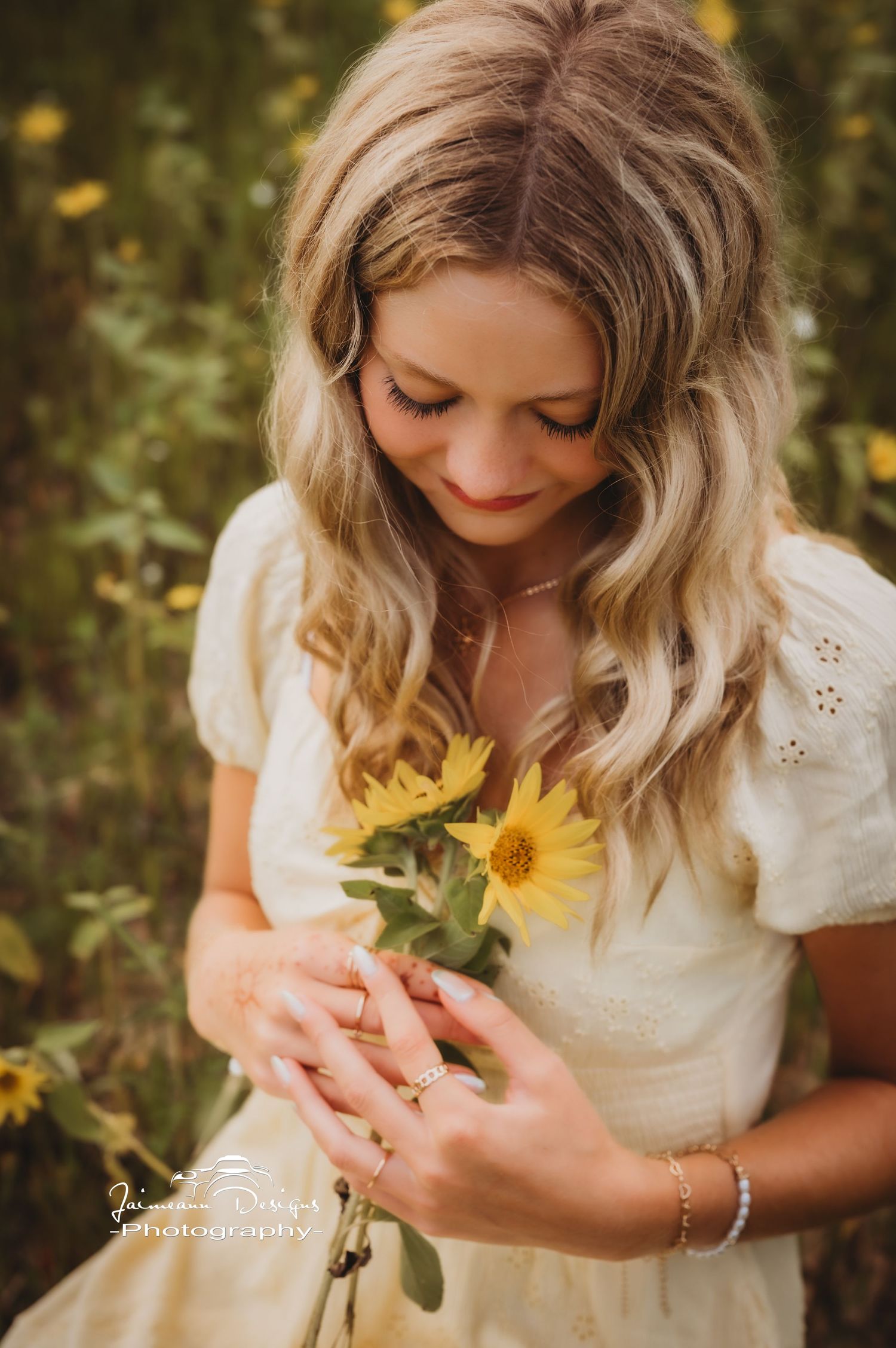 Close-up shot of person holding sunflower while wearing white vintage dress.