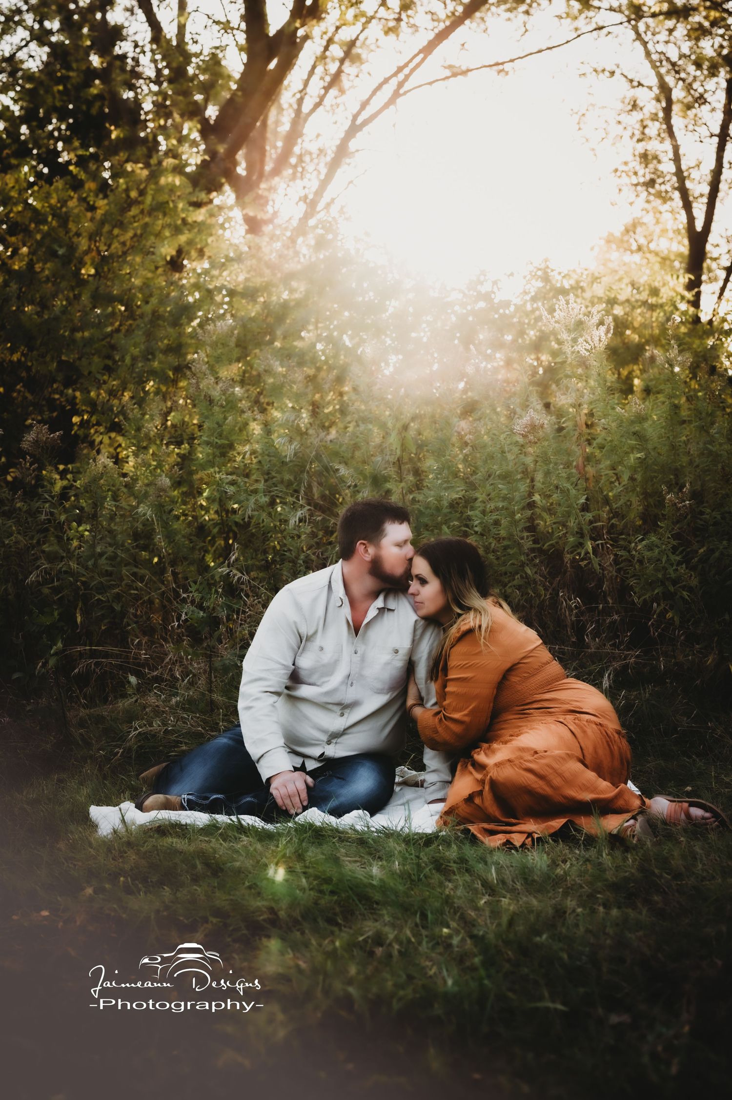A romantic sunset picnic scene in a forest clearing with warm golden light filtering through the trees.