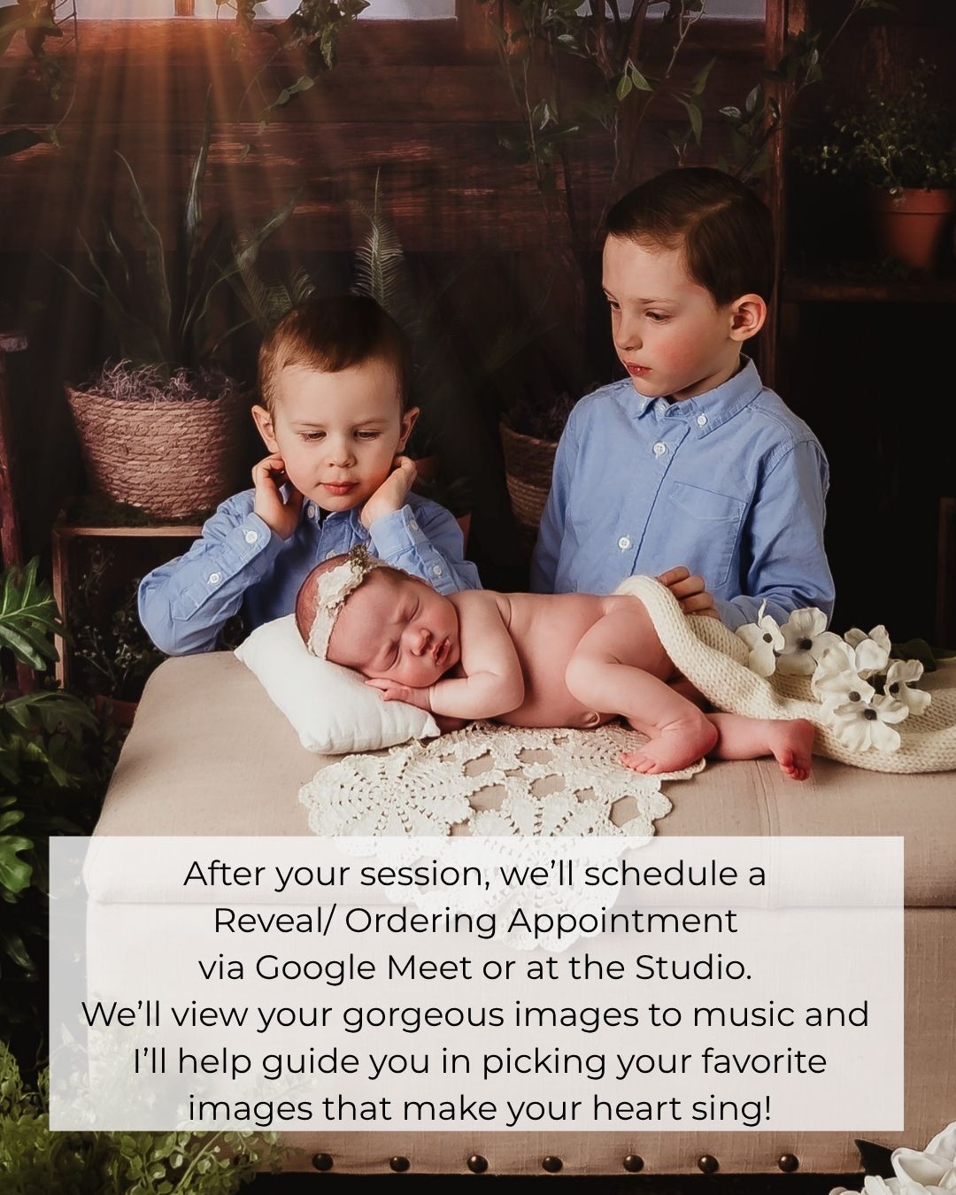 Two boys in blue shirts pose with a sleeping newborn baby in a studio photography session with warm lighting.