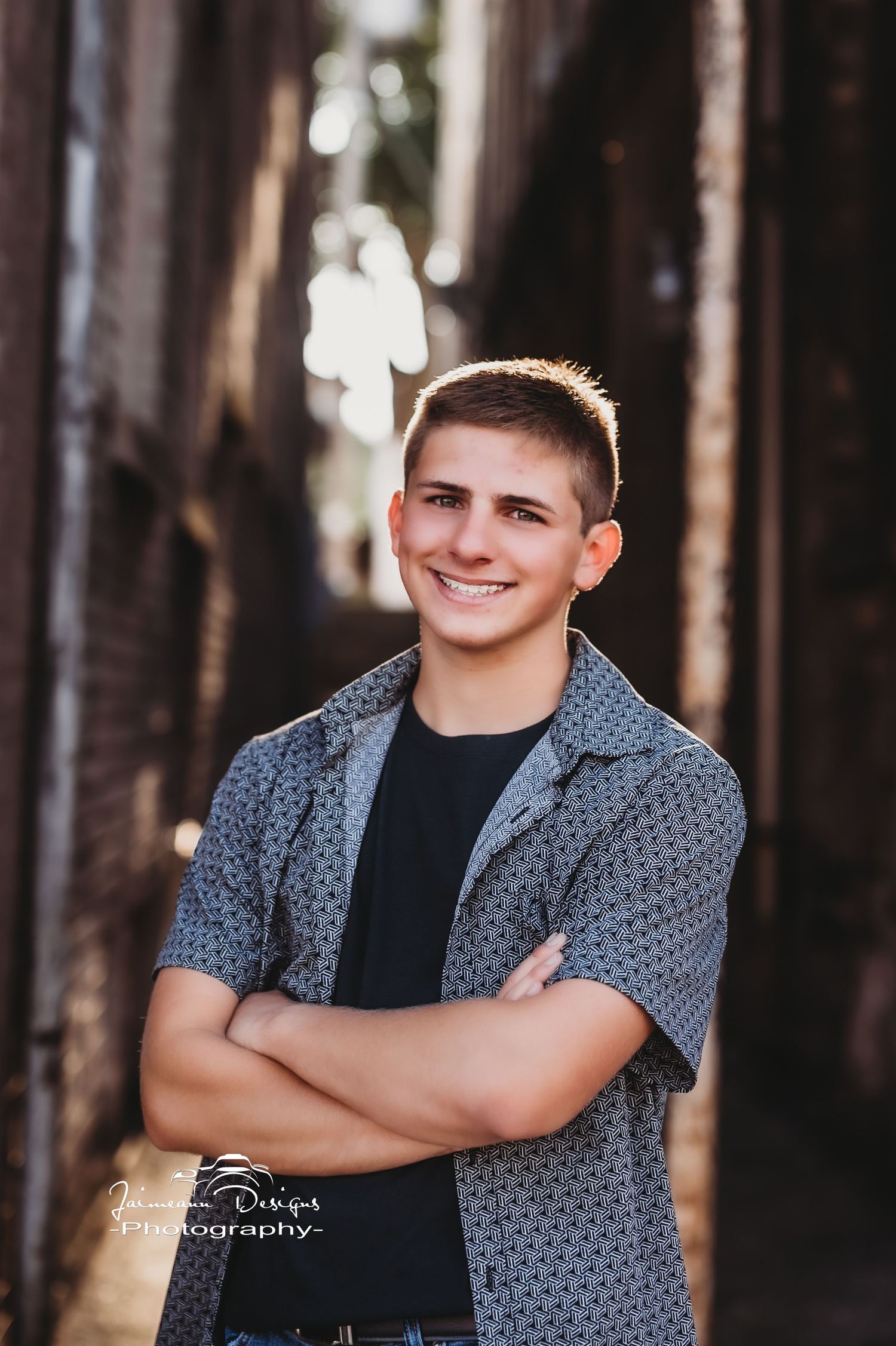 Portrait in urban alley with soft lighting and brick background.